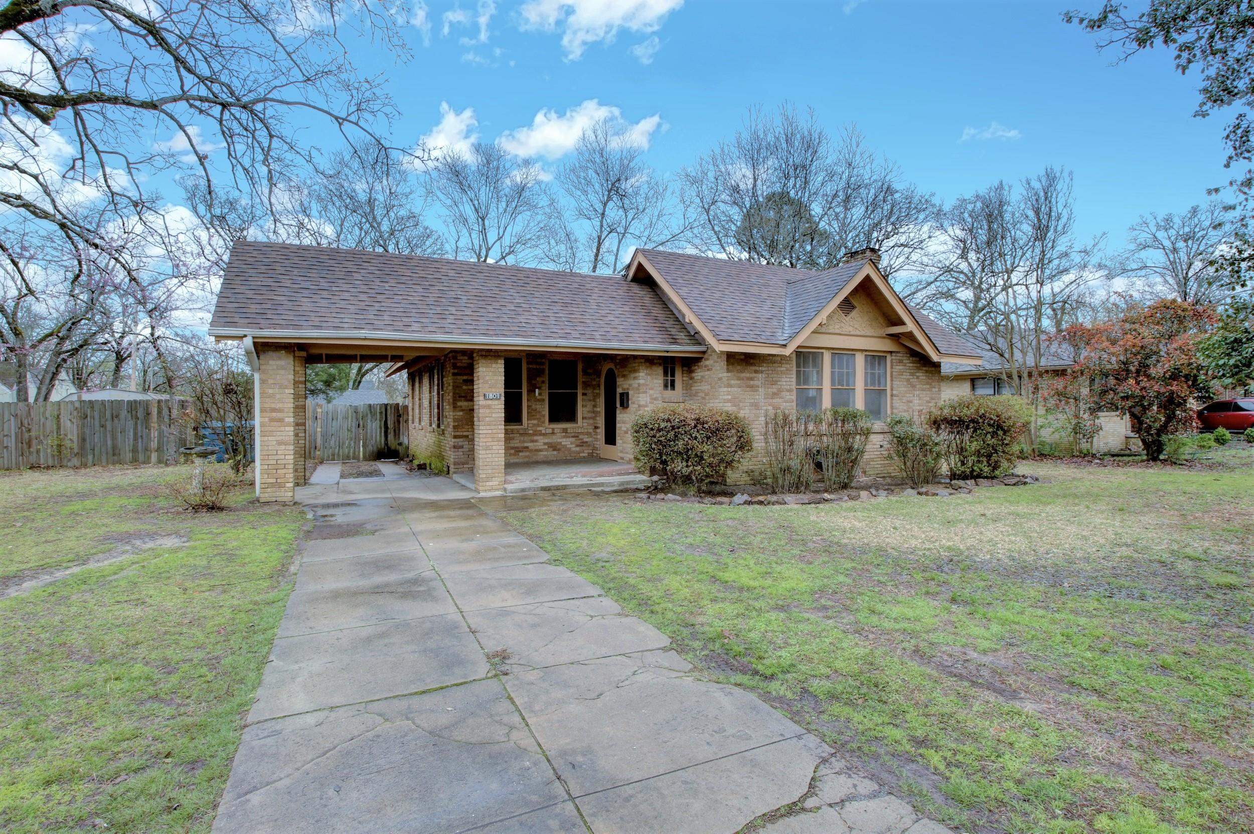 On a corner lot with mature trees, this home features a gas fireplace flanked with bookshelves, original moldings and hardwood floors, a dedicated laundry room, large dining room, covered back porch, kitchen pantry, and extra closet space. The office/sunroom has an outdoor access to a fully fenced backyard with a storage building. The office/sunroom area could be used as a third bedroom.