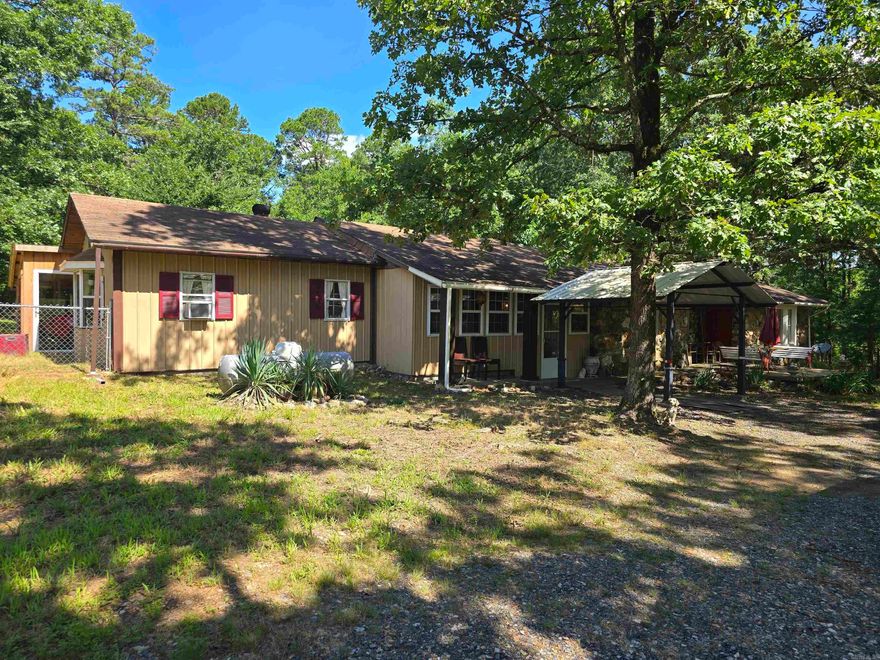 Nestled in the picturesque Board Camp Area, this charming 2-bedroom, 2-bathroom home offers a unique blend of comfort and eclectic style. Situated on 2 acres, the property provides ample space and privacy, including a partially fenced backyard perfect for pets or outdoor activities. Step inside and be greeted by a striking entry featuring a beautiful rock wall, setting the tone for the home's distinctive character. The interior boasts an efficient layout with a dedicated office area, ideal for remote work or creative pursuits. A large laundry room adds convenience to daily living. Outdoors, you'll find a welcoming patio in the front yard, perfect for enjoying your morning coffee or evening sunsets. A useful storage building in the backyard provides extra space for tools and equipment. One of the property's prime features is its proximity to the Ouachita River, just 1.7 miles away, offering easy access to fishing, kayaking, and other recreational activities. This home is a true gem for those seeking a tranquil retreat with unique style and convenient access to nature.