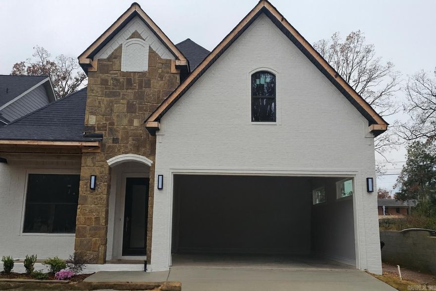 Experience elevated elegance and Midtown convenience in the new Oak Glen subdivision. This stunning home—the second of nine—offers 2,675 sq ft of luxury and thoughtful design. With 4 bedrooms, 3 full baths, a great room, bonus room, and laundry room, it blends comfort and craftsmanship throughout. Enjoy porcelain flooring and quartz countertops, plus a chef’s kitchen with stainless appliances, gas range, walk-in pantry, and breakfast bar. The dining and living areas feature soaring 20-ft ceilings and a striking floor-to-ceiling porcelain fireplace with illuminated stone accents. The primary suite includes a large walk-in closet, porcelain tile shower with jets and rain head, and a modern soaking tub. Custom details include raised accent walls, lattice beam ceiling, heavy crown molding, iron railing, and exposed wood beams. Outdoor living shines with a covered front porch, covered back patio with wood-burning fireplace, wood ceiling, fully fenced yard, security and sprinkler systems, spray foam insulation, storm room, and tankless hot water. A true standout! Completion Date January 2026