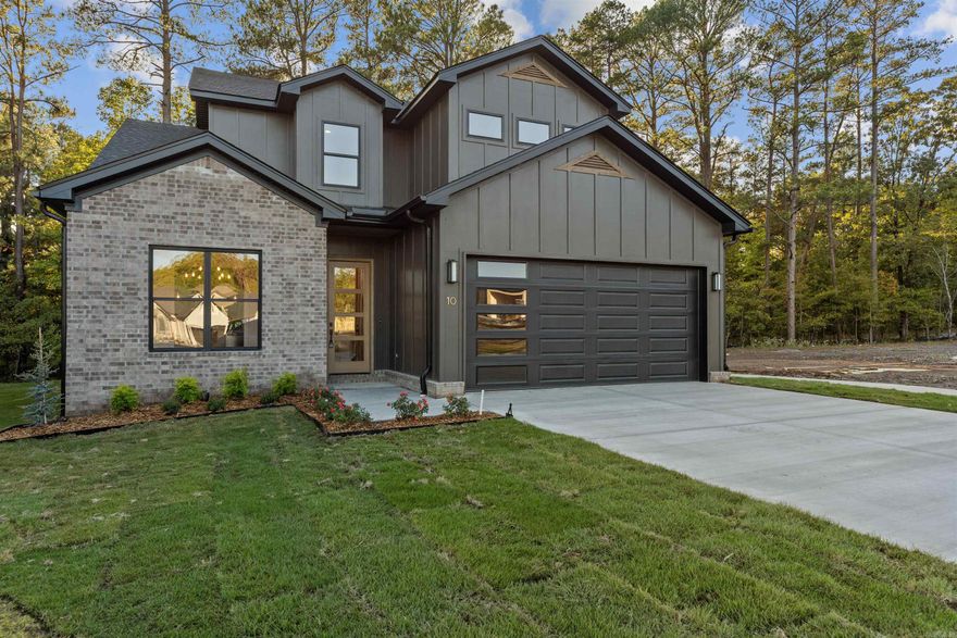 Wow factor in Woodlands Park! This designer curated masterpiece is one of the most striking homes in this brand new West Little Rock community! 10 Woodlands Park Lane offers custom features around every turn, including awe-worthy beam work, a floor to ceiling tile fireplace, on-trend accent wall, and so much more! This functional layout is both practical & stylish featuring a dining room that opens into your chef's kitchen which features custom cabinetry, quartz counters, and a stellar sightline into your living area with 12 ft ceilings & an abundance of windows. Enjoy cozy Fall evenings on your covered back porch that features views of both a protected greenspace & a charming pond. The exterior fireplace is going to be one of your favorite features! Tired of mowing? Woodlands Park offers front & back lawncare with your yearly POA dues, and that will come in handy as this home offers the largest yard in the community. Offering 4 bedrooms & 3 full bathrooms with an additional bonus room upstairs, this is the one you have been waiting for!