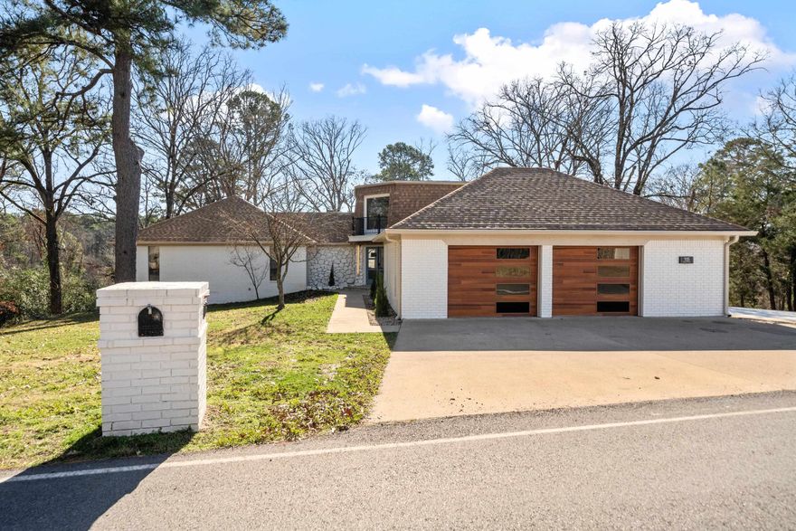 This tastefully updated Lake Hamilton home is nestled on over 1.7 waterfront acres. This is a rare find, offering the perfect combination of spacious land and lake-front recreation. Inside, the 4 bedroom, 4 bathroom home features stunning updates & finishes, including a gorgeous master suite with a huge walk-in closet, a soaker tub, and his/hers tiled showers. You'll love the main living area with a cozy electric fireplace and large windows that flood the home with natural light.  Downstairs, you'll find a spacious family room/man cave with a stone fireplace, 1 bedroom, a full bath and a beautiful built-in bar.  Step outside to an outdoor oasis with direct lake access, a charming gazebo covering the outdoor kitchen area, and over 1.5 acres of land. Don't miss this opportunity to own a truly exceptional Lake Hamilton property.