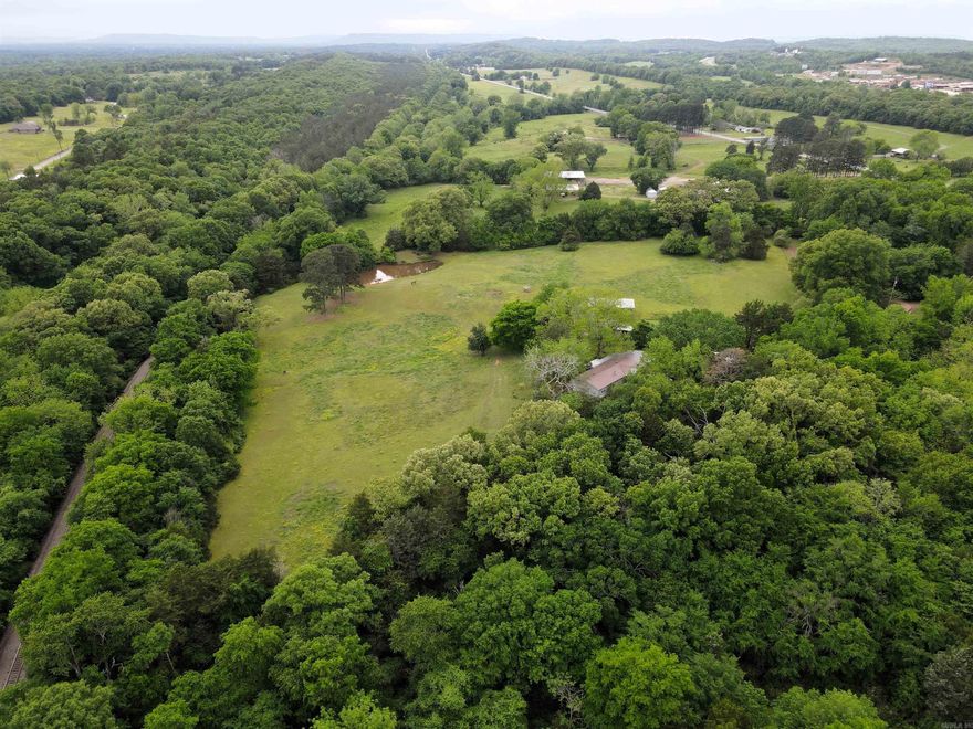 This 11.5 +/- acre farm offers a well-rounded blend of functionality, space, & convenience. Just 3/4 of a mile from I 40 this small acreage property offers the convenience of travel to shop or dine just minutes from Conway or Morrilton, while featuring the ease of life in a small town. The 1960 square foot home provides comfortable living in a peaceful rural setting, making it an ideal base for those looking to enjoy country life without sacrificing accessibility. The land is mostly open pasture, fully enclosed with perimeter fencing & ready for livestock. A pond provides a reliable water source & mature trees are scattered about the pasture & along the fences for shade, adding both practicality & appeal for farm use. Zoned AI (Agri Improved), the property supports a wide range of uses—from hobby farming to more serious agricultural operations.  Supporting improvements include a 50x30 pole barn along with two utility sheds (22x30 and 24x28), giving you ample space for equipment, storage, or workspace. With the infrastructure already in place and room to expand, this property is well-suited for anyone looking to put their land to work while enjoying the benefits of a rural homestead