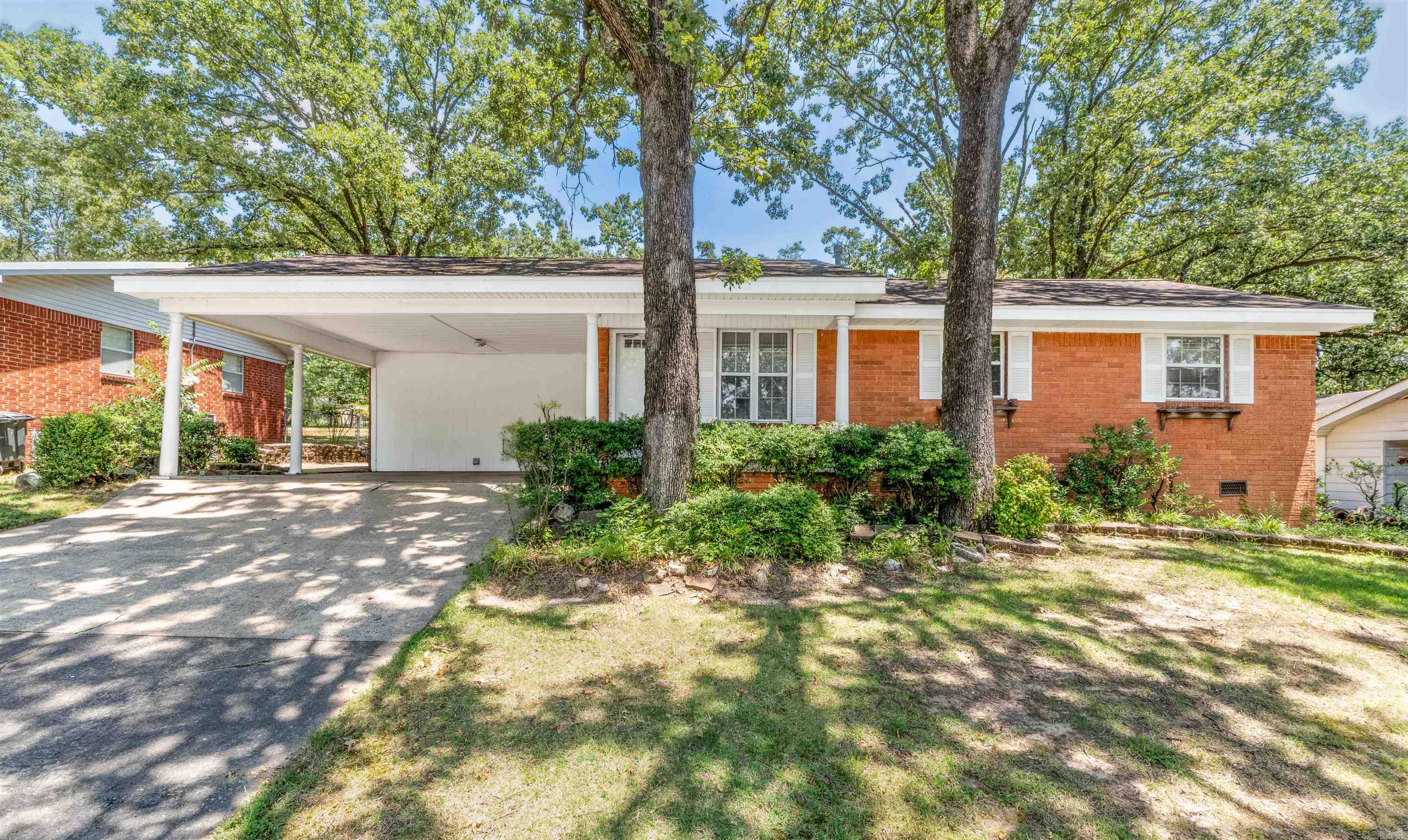 Discover comfortable living in this delightful 3-bedroom, 1.5-bath residence, ideally situated on a generous .25-acre lot in a serene Sherwood setting. Mature trees grace the property, providing ample shade and a picturesque backdrop. Step inside and envision the possibilities! While currently partially carpeted, beautiful hardwood floors lie beneath throughout most of the house, offering the potential for a classic and elegant touch. The expansive living room, featuring a cozy gas log fireplace, provides a perfect space for relaxation and entertaining. For your morning coffee or a quiet read, the bright sunroom at the back of the house offers a wonderful, peaceful sitting area. Outside, the large, treed backyard is a true oasis, providing a peaceful retreat with plenty of room for outdoor activities, gardening, or simply enjoying the tranquility. A convenient detached shed with power offers versatile space for hobbies, tools, or extra storage. This property beautifully combines the tranquility of a spacious, private lot with the convenience of a well-located home in Sherwood. Don't miss the opportunity to make this charming house your own! Square foot approximate please measure.