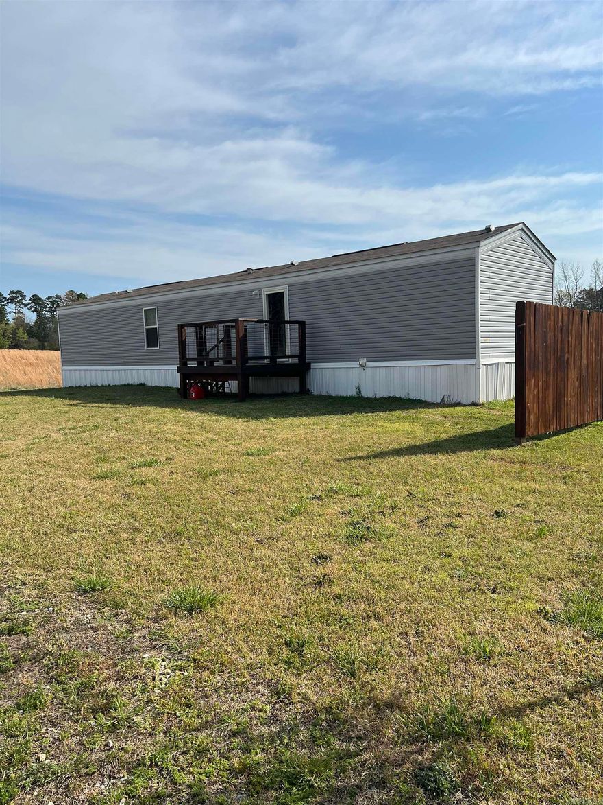 Enjoy the country with this beautiful 2 bedroom 2 bath, covered back porch, all water lines are under ground encased in PVC pipe pex pipe inside. This 2023 mobile home sitting on 4 spacious acres is a perfect mix of privacy, functionality, and room to grow. Large 20x25 Shop building with  roll-up door great for storage, hobbies, or equipment.  Whether you're looking for a full-time residence, weekend retreat, or investment property, this one checks all the boxes. 300 feet lateral line, wholle house exhaust fans, upgraded insulation, smart thermostat, smart hot water heater runs on WiFi, electric $60. Per month, much more.