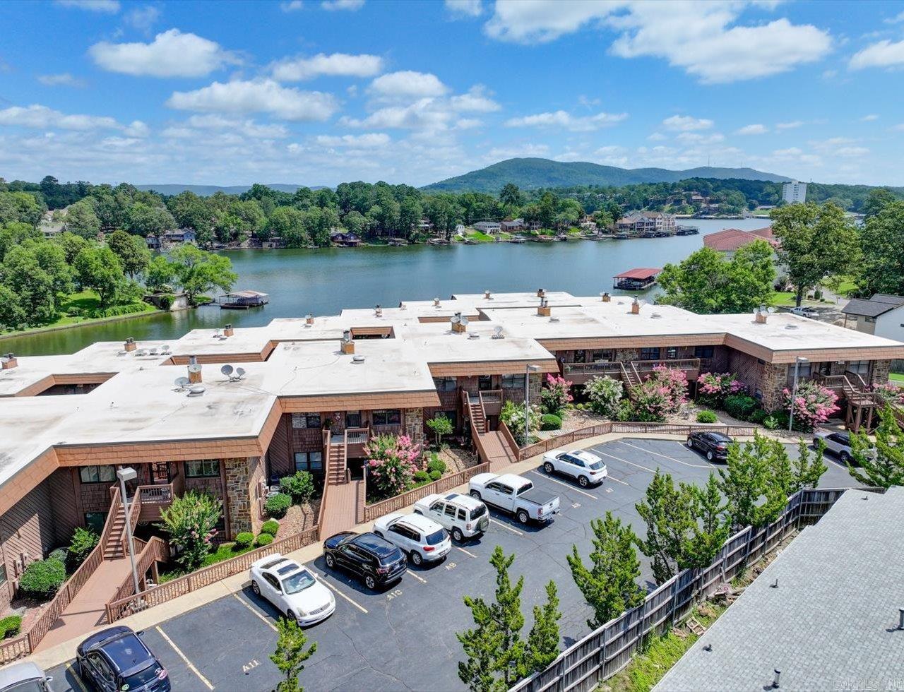 UPDATED FIRST FLOOR 2-bed, 2-bath condo offers 1,360 sq ft of stylish comfort at The Harbor - a Lake Hamilton condo community. The gated community provides a resort-like lifestyle with a shimmering pool, a scenic boardwalk for morning or evening walks, and a swim dock perfect for enjoying the summer. This unit is move-in ready with the following Seller Updates: - Full remodel throughout (except master bath) - Fresh paint on walls and ceilings (except master bedroom) - New baseboards and crown molding throughout - Kitchen: Removed walls to open layout, new tile floors, counters, backsplash, farmhouse sink, appliances, lighting, spice cabinet, and barn-door pantry - Guest Bath: New tile, vanity, lighting, and resurfaced tub/shower - Systems/Exterior: New water heater and deck carpet installed Ideally situated close to shopping, dining, and medical services, this location offers convenience and comfort. Whether you're looking for a full-time home, a weekend getaway, or investment opportunity, this property has it all. See the attached complete list of Seller updates since purchase. Agents - please schedule all showings with Showing Service.
