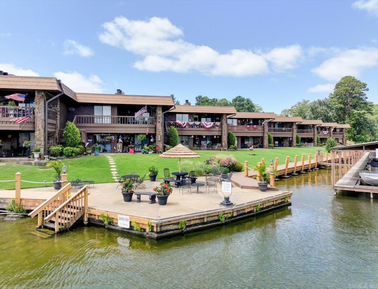 UPDATED FIRST FLOOR 2-bed, 2-bath condo offers 1,360 sq ft of stylish comfort at The Harbor - a Lake Hamilton condo community. The gated community provides a resort-like lifestyle with a shimmering pool, a scenic boardwalk for morning or evening walks, and a swim dock perfect for enjoying the summer. This unit is move-in ready with the following Seller Updates: - Full remodel throughout (except master bath) - Fresh paint on walls and ceilings (except master bedroom) - New baseboards and crown molding throughout - Kitchen: Removed walls to open layout, new tile floors, counters, backsplash, farmhouse sink, appliances, lighting, spice cabinet, and barn-door pantry - Guest Bath: New tile, vanity, lighting, and resurfaced tub/shower - Systems/Exterior: New water heater and deck carpet installed Ideally situated close to shopping, dining, and medical services, this location offers convenience and comfort. Whether you're looking for a full-time home, a weekend getaway, or investment opportunity, this property has it all. See the attached complete list of Seller updates since purchase. Agents - please schedule all showings with Showing Service.