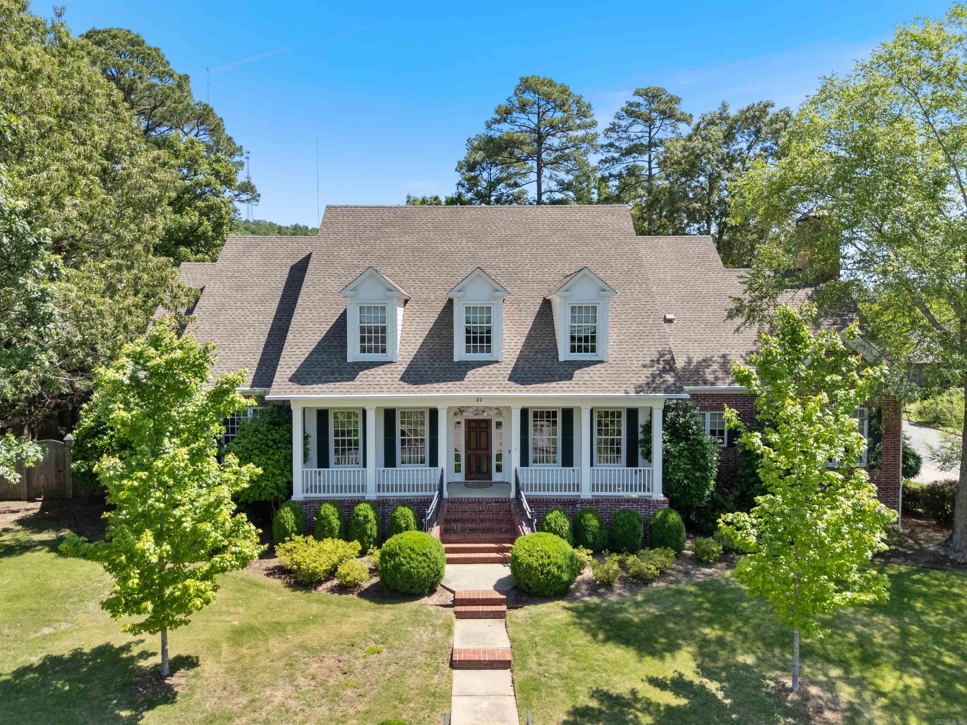 Located in Chenal Valleyās "Germay Court", this custom-built home offers timeless design in a premier gated golf community. Set on a manicured corner lot with golf cart access to the Bear Den Golf Course, this home features a fabulous floor plan. The welcoming entry opens to newly refinished oak hardwood floors in a herringbone pattern adjacent to the formal dining room and office with grasscloth wallpaper, maple trim, and custom built-ins. The great room features built-ins, a gas fireplace, and French doors opening to the backyard. The remodeled chefās kitchen boasts soapstone and marble countertops, Ann Sacks backsplash, new Wolf gas cooktop, double ovens, new dry bar with Sub-Zero beverage fridge, new Miele dishwasher and a KitchenAid fridge. The kitchen is open to the hearth room with vaulted wood ceiling and breakfast nook with banquette seating and a nearby half bath. The primary bedroom suite offers a sunroom, dual closets, and spa-like bath. A guest suite is also on the main level. Upstairs offers 2 en-suite bedrooms + game room. Other features include a backyard with lush landscaping, a wooden privacy fence, a covered patio with convenient access to the three-car garage.