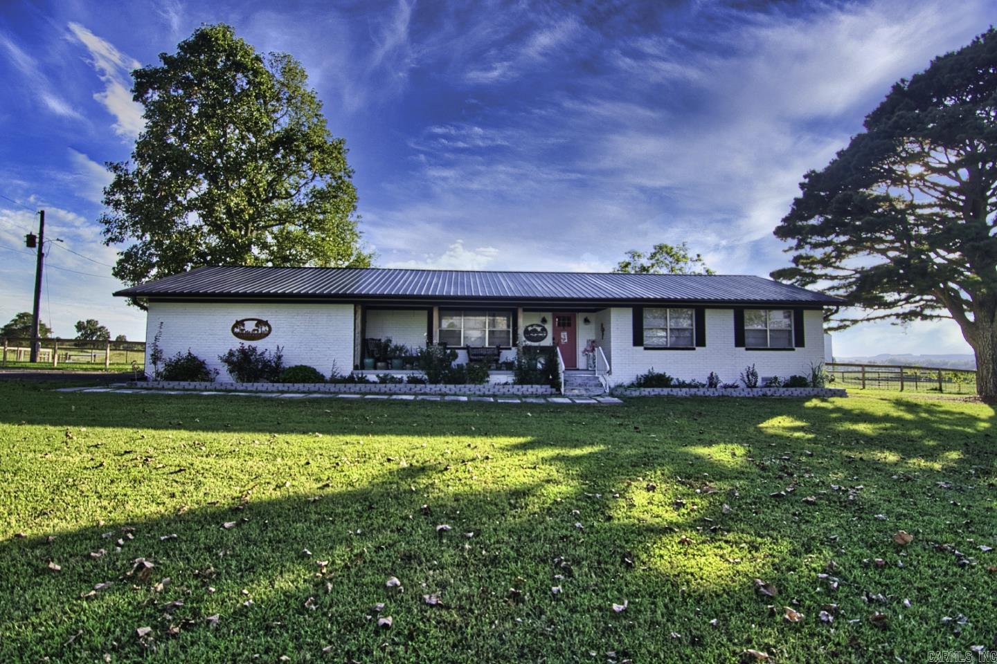 Welcome to your dream home ! This charming 3-bedroom, 3-bathroom home spans 1,750 square feet and is nestled on a sprawling 55 acres of versatile land that can be utilized for farming or livestock. The stunning kitchen equipped with a butcher block countertop and a large pantry that conveniently connects to a separate laundry area. Step into the cozy living space, complete with an electric fireplace that adds warmth and ambiance. Each bedroom is generously sized, with the primary suite offering a luxurious bathroom featuring a clawfoot tub and double hand-painted vanity sinks for a touch of elegance. The property features a public water supply, complemented by a new well for irrigation, making it ideal for agricultural endeavors. The farmhouse boasts a spacious 400 square foot garage. Enjoy outdoor living on the new Trex deck, perfectly shaded by a stylish pergola, while the sizable barn provides ample storage and functionality for your farming needs. With a durable metal roof and picturesque surroundings, this property offers the perfect blend of comfort, utility, and rural charm. Don't miss this opportunity to own a slice of paradise!