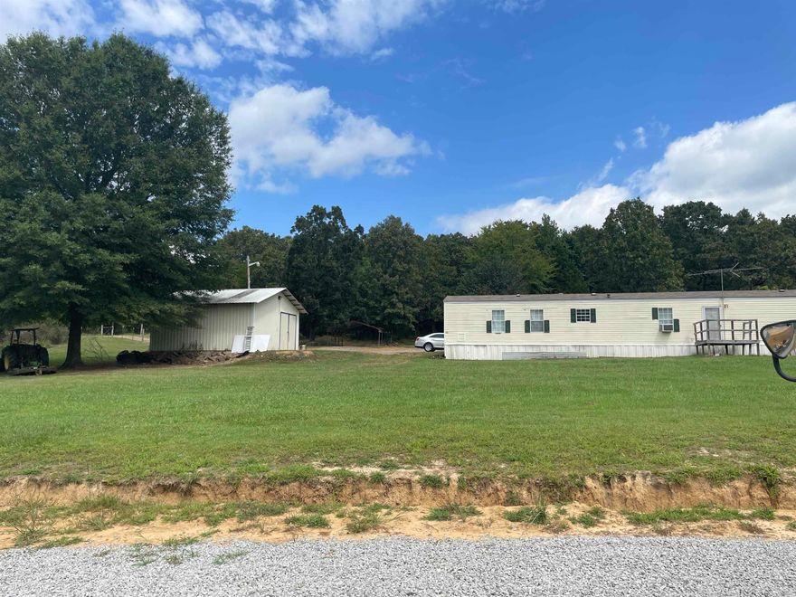 Single wide mobile home with a 25x25 concrete slab, wired, shop. Tenants currently in home, need 24 hour notice.  Beward of dogs.