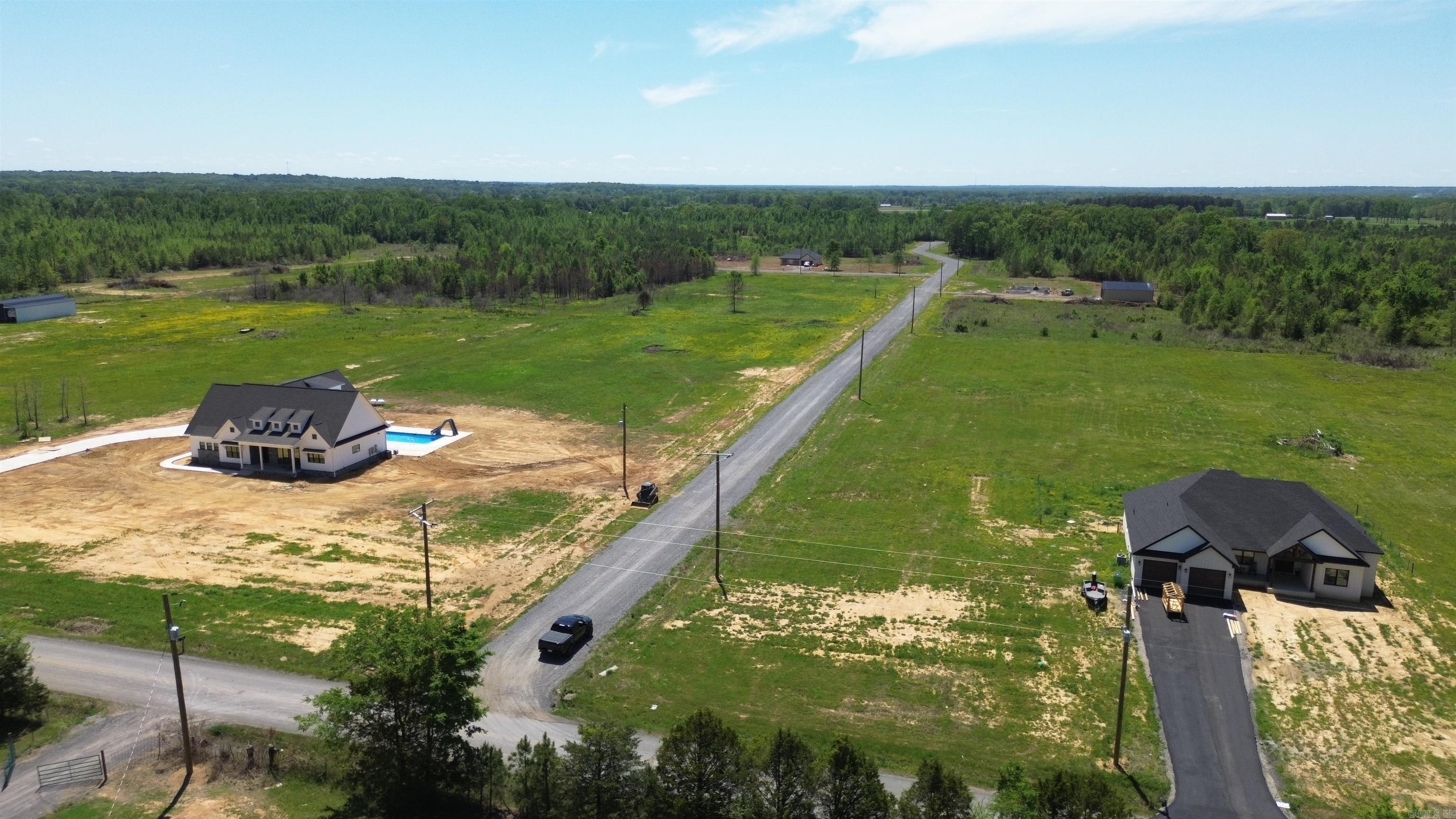 Beautiful flat 6.04+/- acre lot right outside of city limits, perfect spot if you are looking to build! Gorgeous new construction houses are going in all around. Enjoy great views of the countryside in a quiet area while only being a few minutes from the interstate. 20 mins to Vilonia, 20 mins to Searcy, & 20 mins to Cabot. Water and electric are available at the road. No mobile homes. Minimum square footage of 1700.