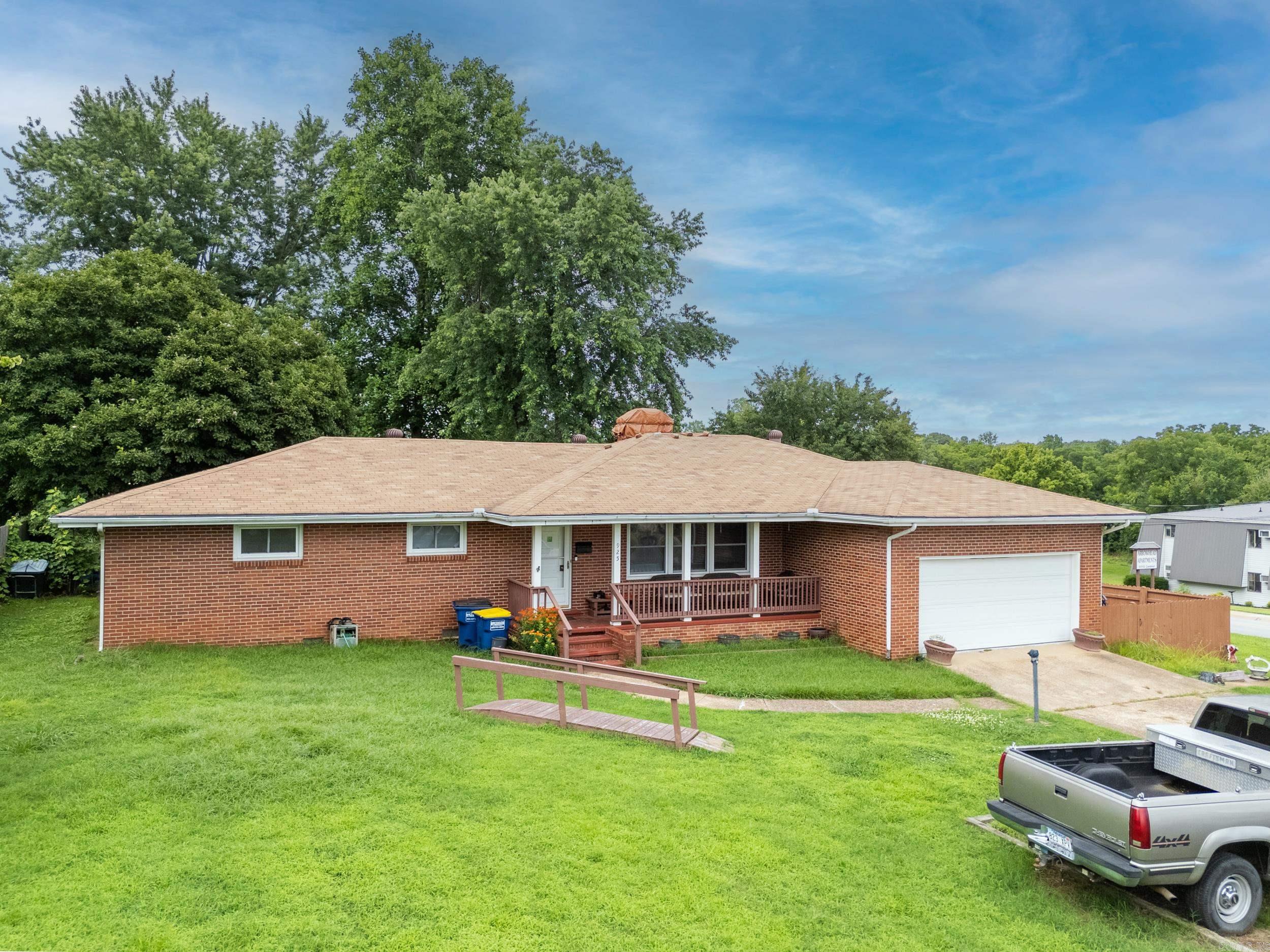 This charming 3 bed, 2 bath all-brick home sits on a spacious corner lot in the city limits. Enjoy a cozy wood-burning fireplace, bright sunroom, large fenced backyard with two storage sheds, and a private enclosed patio. With a 2-car garage and great location, this home offers comfort, space, and convenience all in one!