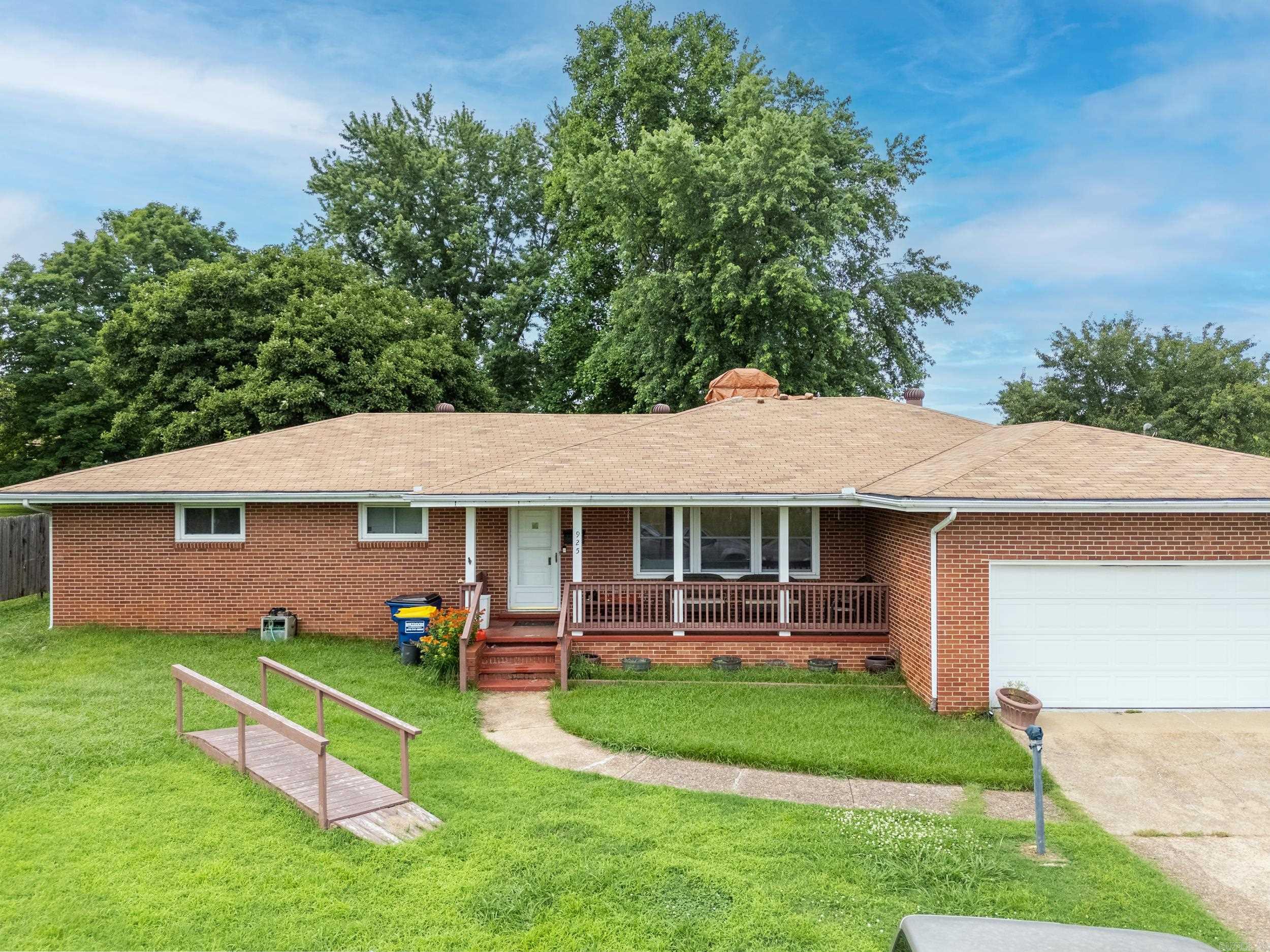 This charming 3 bed, 2 bath all-brick home sits on a spacious corner lot in the city limits. Enjoy a cozy wood-burning fireplace, bright sunroom, large fenced backyard with two storage sheds, and a private enclosed patio. With a 2-car garage and great location, this home offers comfort, space, and convenience all in one!