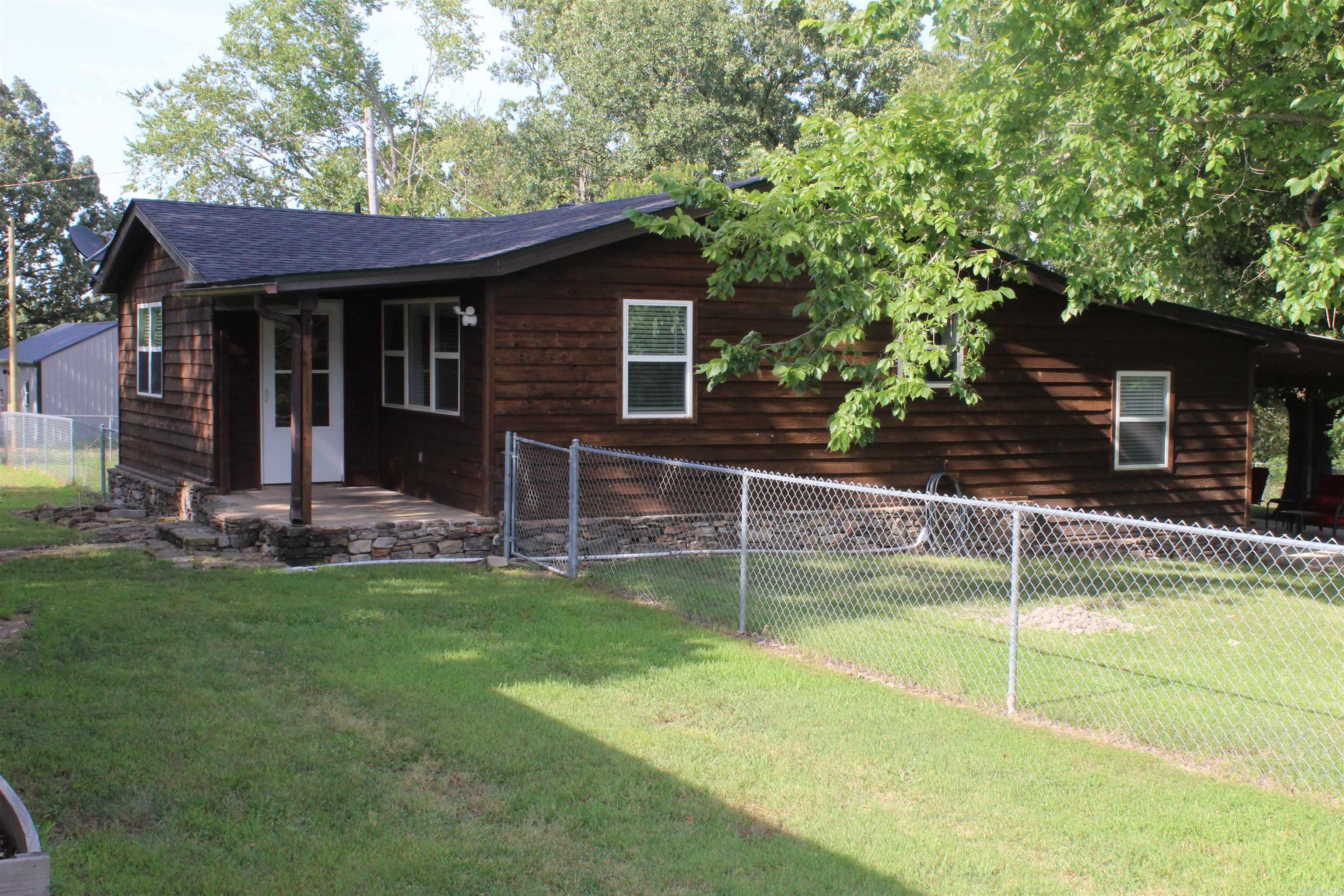 Ideal Getaway, Forever Home, or Airbnb! Remodeled, move-in-ready 3-bedroom, 2-bathroom home offers comfort, space, and outdoor enjoyment. With State Highway frontage for easy access, ideal as a full-time residence, weekend retreat, or short-term rental investment. Fiber internet available, making it easy to stay connected for working remotely or streaming your favorite shows. Step inside to find a bright, updated interior, featuring a private primary suite complete with a walk-in shower and direct access to a spacious covered patio—perfect for grilling, relaxing, and watching the abundant l wildlife. The expansive yard offers plenty of space for gardening, and a chain-link fence around three sides provides a secure area for pets to roam. A detached 960 sq ft garage/shop offers versatile space for storage, hobbies, or a workshop. Enjoy the peace and quiet of the countryside with the convenience of being just 10 minutes from Marshall for daily essentials and dining. Branson, MO is just 1.5 hours away for shopping and entertainment. Only 20 minutes to the Buffalo National River where you can enjoy fishing, kayaking, canoeing, hiking, and numerous outdoor activities! Don't miss out!!