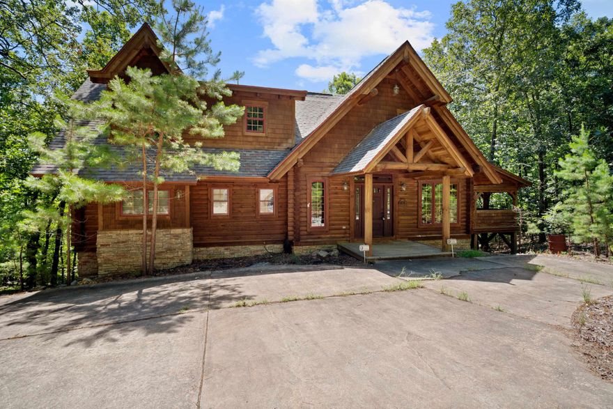 Welcome to your dream retreat in the heart of Hot Springs Village! This stunning log cabin, situated on 2 private acres, offers the perfect blend of rustic charm and modern comfort. Surrounded by the natural beauty of the Ouachita Mountains, this spacious home boasts soaring wood ceilings and an abundance of natural light, a stone fireplace, and a wraparound porch for enjoying peaceful mornings. The expansive downstairs area is perfect for entertaining and plenty of space for extra guests to stay, while the thoughtfully furnished interior ensures a seamless move-in experience. Whether you're looking for a peaceful retreat or a warm and inviting space to host friends and family, this log cabin is a true gem waiting to be called home. With plenty of room to expand, garden, or simply enjoy the tranquil setting, this is the escape you've been waiting for. Don’t miss this rare opportunity to own a slice of paradise in a gated community known for its golf courses, recreation, and security. Schedule your private showing today!