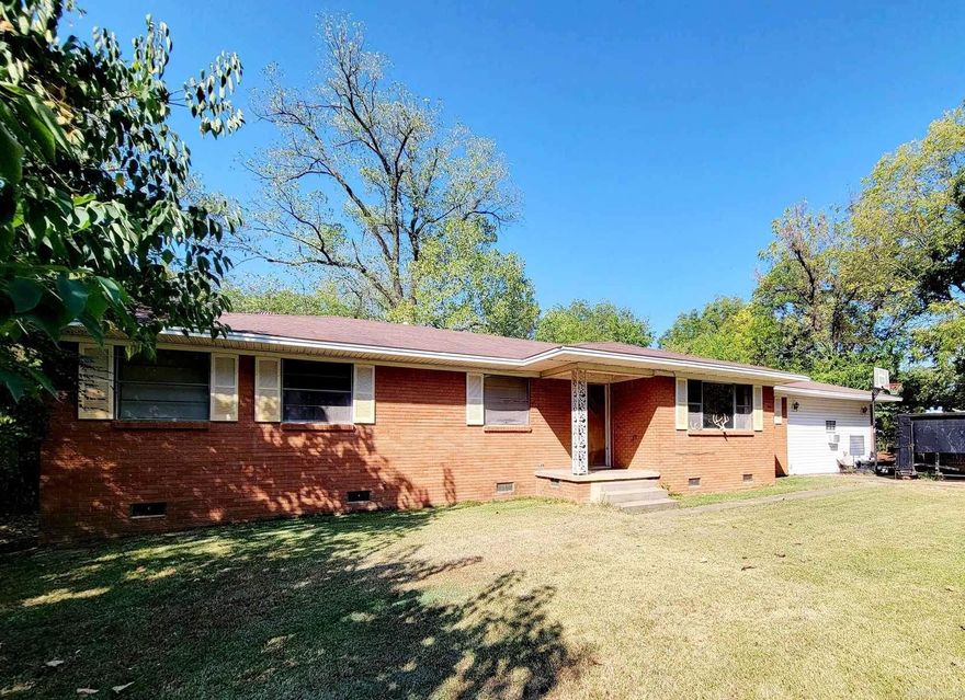 Brick home with 4 bedrooms, 1.5 bathrooms, office area and more. This home sits on numerous lots to make it a large amount of land to be in town and it even includes a workshop. Most of the acreage is wooded. There is plenty of room for a garden.