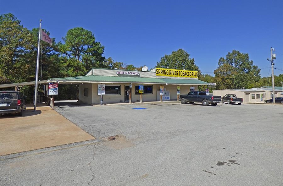Commercial Building and Land in Prime Location! Property is level with a 1,240 square foot building that currently houses the Tobacco Plus business, has an office, restroom, and walk-in "beer cave" cooler. Along with accommodating walk-in customers there's an easily accessible drive-up window for the in & out customer. The current business generates a profitable monthly income. This one-level building has central heat & air, city water and sewer, fronts on the 4-lane U. S. Highway 62/412 in a high traffic area with high visibility and easy drive-in and out access. Call today and look at this property.