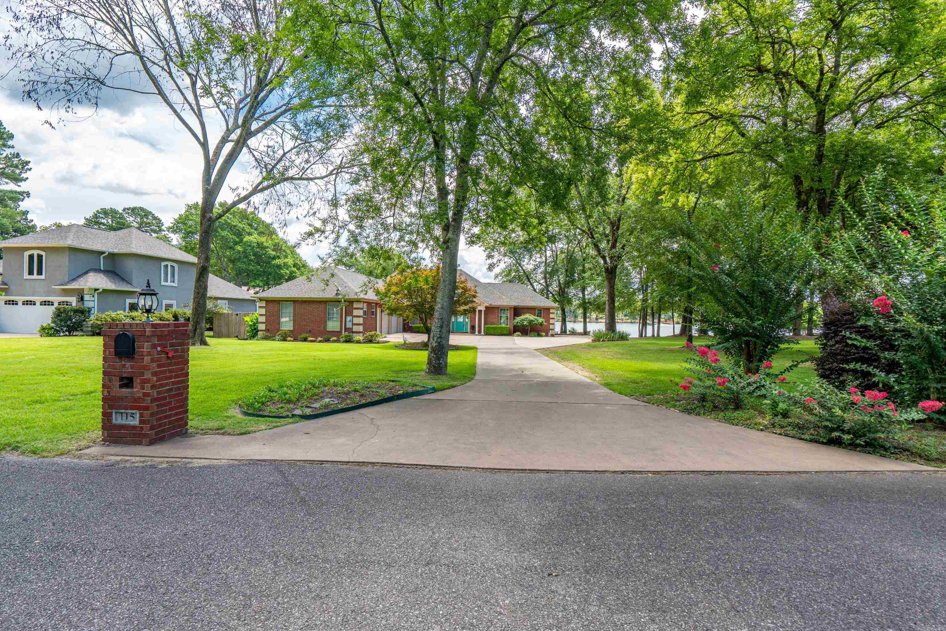 115 BIG DUKE IS AN ABSOLUTELY STUNNING WATERFRONT SETTING - IN A LOVELY AREA OF ONLY 5 HOMES! Rarely available is a LEVEL LOT featuring an extremely nice SINGLE LEVEL HOME! This 2005 built 3 BR 2.5 Bath split floorpan emphasizes quality throughout and enhances incredible views from every angle - with large windows + lots of light. The Kitchen is great and has granite counters and SS appliances, including a Gas Cooktop, built in Oven & Microwave, Trash Compacter, and a large walk-in pantry! The entire house offers wood, tile and solid surface flooring, including a large Master Suite, and the 2 guest rooms have access to a Jack & Jill bathroom. It is a short distance from the back door to your Covered Boat Dock and the dock accommodates 2 jet skis and a lift for the 2019 G3 Suncatcher Party Barge with 4 Stroke Yamaha Motor, which also conveys with sale. This home also has an oversized garage with ample space for a third vehicle, boat storage or workshop, and be sure to check out the AWESOME attic with a walk-up staircase, flooring, shelving, room to stand + lighting. See showing & agent remarks.