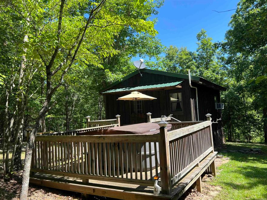 Prime Hunting Retreat with Cabin - 22.5 +/- Acres in Dennard, Arkansas  Discover the perfect blend of adventure and tranquility with this exceptional 22.5 +/- acre hunting and retreat tract in Dennard, Arkansas. This property offers a unique opportunity for hunters and nature enthusiasts alike, featuring abundant wildlife and a charming cabin to complete your wilderness experience.  Key Features:  22.5 +/- Acres of Hunting and Recreation Land:?Explore Ozarks nature teeming with deer, turkey, and other game.  The property is mostly wooded and set up with deer stands and shooting lanes.  There is also a spring and a wet weather creek that flows through the property as well.  Cozy Cabin:?A rustic, fully-equipped cabin provides the ideal base for your getaway retreat. Comfort meets charm in this secluded, fully furnished cabin complete with 4-person hot tub and outdoor shower.  There is also an outdoor firepit for relaxing around the fire.    Gated Entrance:  Ensure your privacy and security with a gated entrance, offering peace of mind and private access to your property.