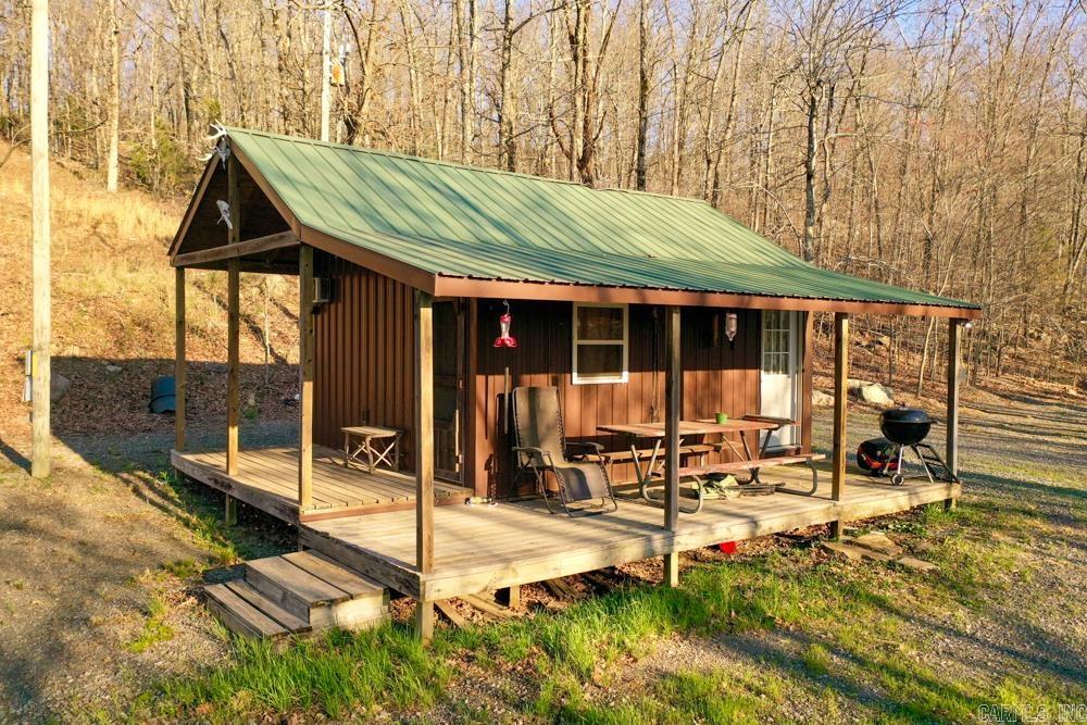Escape to your own private wilderness with this charming 1 bedroom cabin nestled on 20 +/- secluded acres, offering stunning views and unmatched tranquility. Perched above a peaceful valley, the cabin is perfectly positioned for enjoying the natural beauty of the Ozarks, with a couple of benches located just below the cabin that are ideal for observing wildlife that frequently travels through these natural corridors. Whether youāre looking for a peaceful getaway, a hunterās paradise, or a basecamp for outdoor adventure, this property delivers. The cabin provides the seclusion and privacy you crave, yet itās conveniently located only 30 minutes from the Buffalo National River - a nationally recognized destination for canoeing, kayaking, fishing, and hiking.