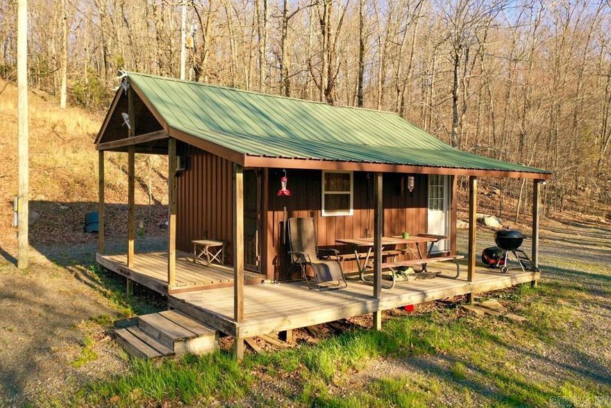 Escape to your own private wilderness with this charming 1 bedroom cabin nestled on 20 +/- secluded acres, offering stunning views and unmatched tranquility. Perched above a peaceful valley, the cabin is perfectly positioned for enjoying the natural beauty of the Ozarks, with a couple of benches located just below the cabin that are ideal for observing wildlife that frequently travels through these natural corridors. Whether you’re looking for a peaceful getaway, a hunter’s paradise, or a basecamp for outdoor adventure, this property delivers. The cabin provides the seclusion and privacy you crave, yet it’s conveniently located only 30 minutes from the Buffalo National River - a nationally recognized destination for canoeing, kayaking, fishing, and hiking.