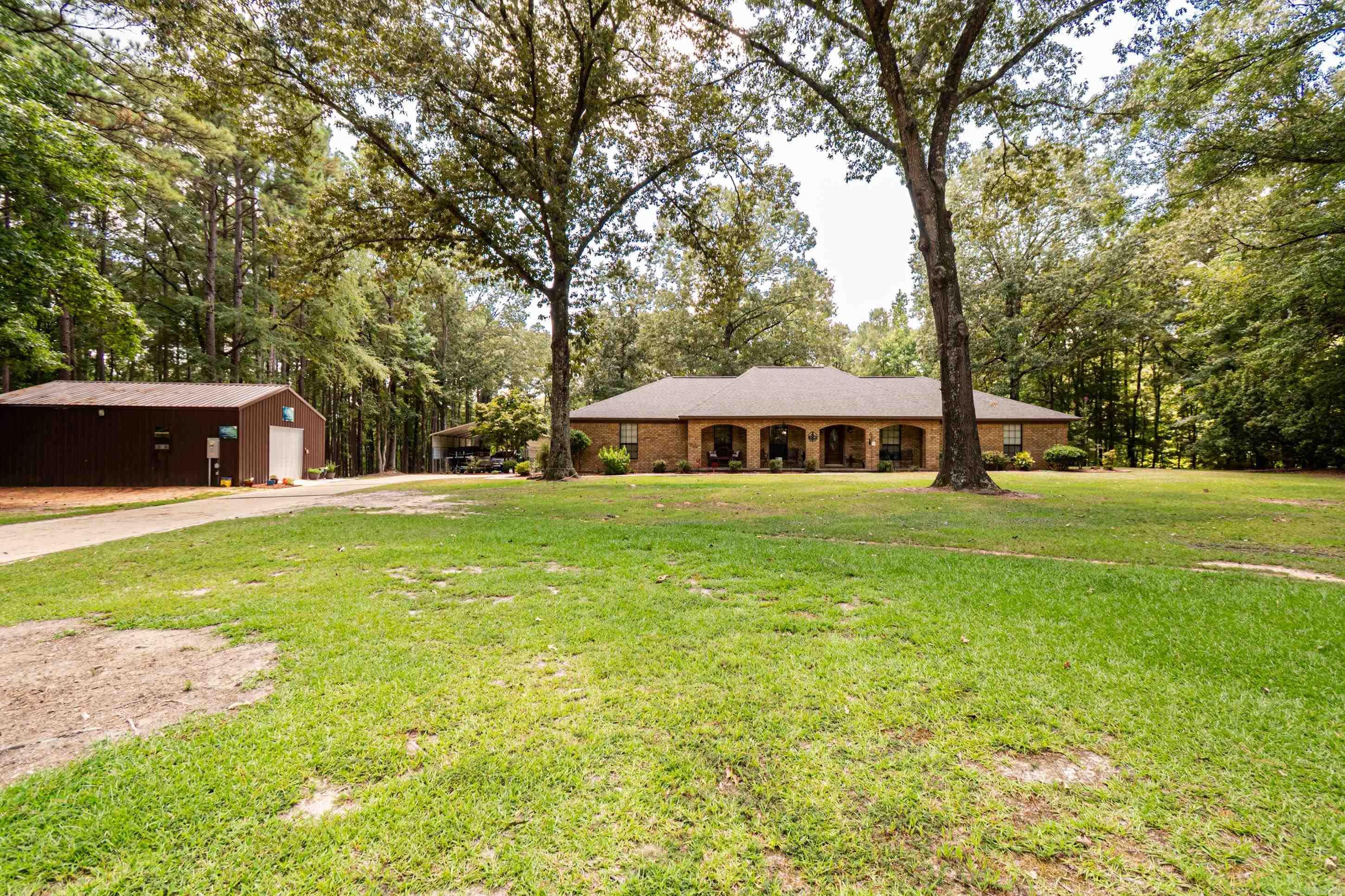 This well-kept home offers an abundance of space in a quiet setting. Sitting on approximately 2.93 acres allows you to have plenty of outdoor room. Section of fenced in area, 2 - detached shop spaces, additional parking space, along with a 2-car garage. A Generator that powers the entire home in the event of a power outage. This one is a must see!