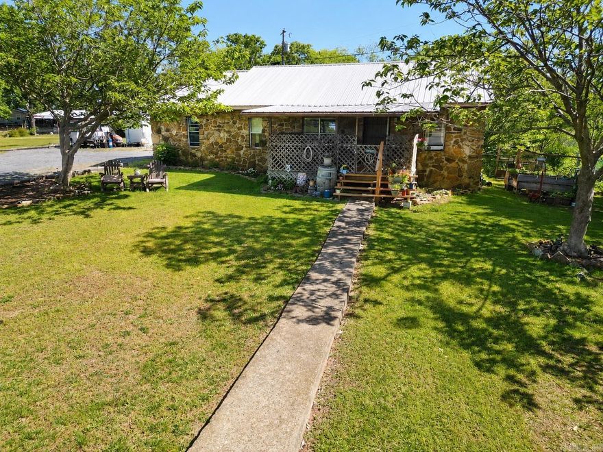 Motivated Seller!  Are you ready to put in your own finishing touches on this 3 bed 1 bath home on 4.67 acres?  Foundational repairs have been done on this home including plumbing and electric upgrades and with a little TLC, you can finish it out how you like.  With a wet weather run off behind the house, the potential is right in front of you for your own pond.  It is just the right amount of land for a few farm animals to start your homestead not too far from town.  Mostly wooded, carve out your own trails through the acreage out back. There is also a pole barn to house them and room enough for a small tractor or yard equipment. Whether you house sheep, goats, chickens and more, be ready for the best of both worlds...access to town, but farm life.  As a bonus, the Buffalo river is just down the road about 20 minutes.  For added storage, the spacious shed is a great spot for a workshop. Do you have what it takes to finish this in your own particular dream style? This property is being sold "AS IS, WHERE IS"