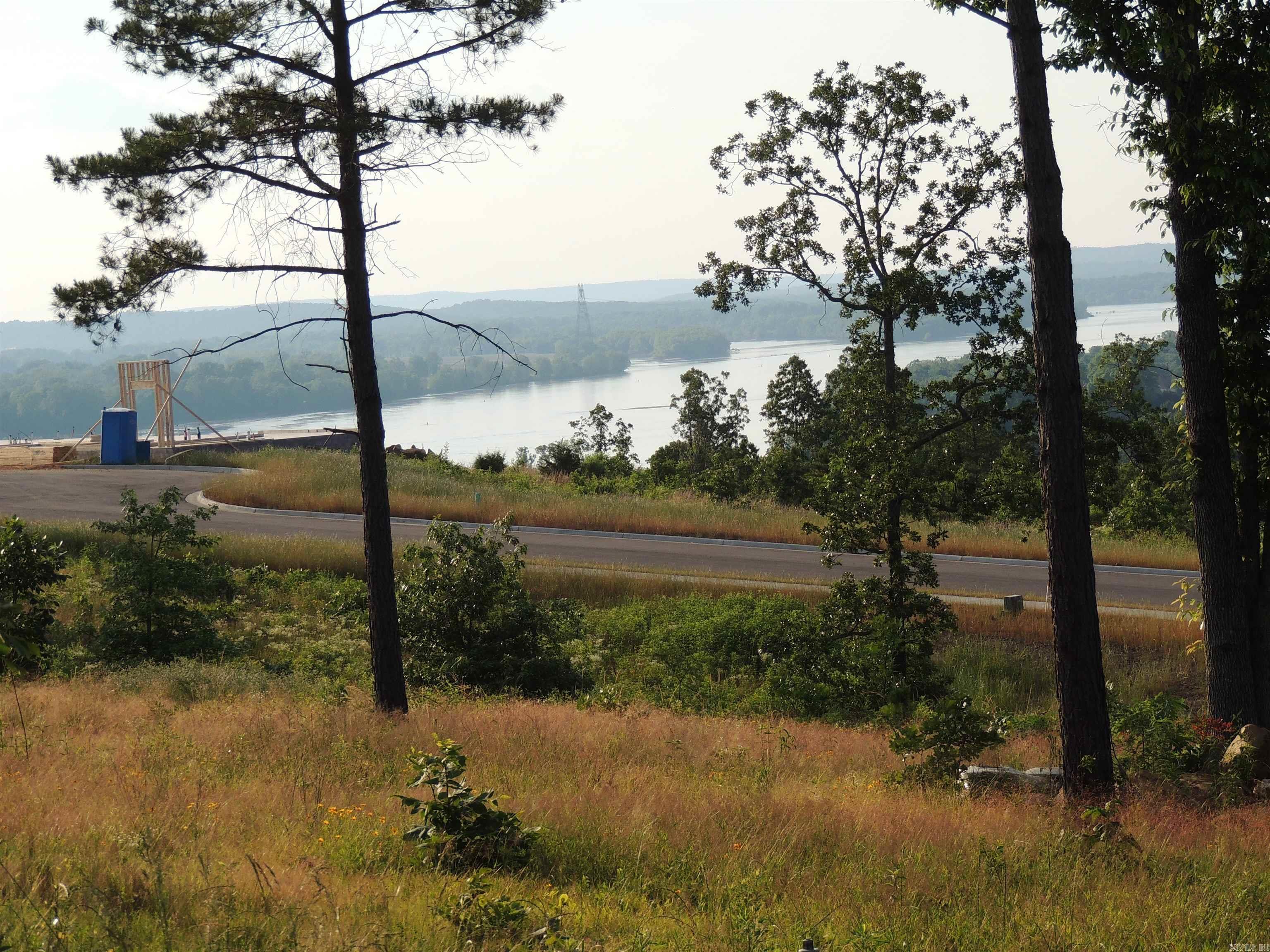 One of Maumelle's most sought after Gated Communities! Great opportunity to purchase this lot in the newest phase! Spectacular views of the Ar River and Pinnacle Mountain with Breathtaking Sunsets!! This neighborhood has some of the most impressive views in Arkansas. Have you always wanted to design your own home? Let me help you make that dream a reality! Call today for a tour of the area! Underground utilities to include; water, electricity, gas, sewer and high speed ATT internet! Minimum sq ft requirements are 2500 sq ft. Gates are open on Sat and Sun from 2-4. You're always welcome!