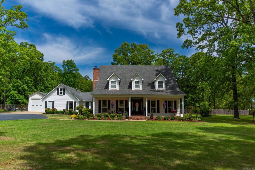 This beautiful white two-story traditional home sits on 2.1 acres inside the city limits, but the real standout is the backyard setup. The spacious patio features a brick fireplace and built-in cooking area, creating the perfect spot for entertaining, watching games, or simply relaxing. The property also includes a large detached boat storage shed, along with a two-car carport and an additional two-car carport with storage in between - offering plenty of covered parking and space for equipment or hobbies.  Inside, the home offers a functional and comfortable layout with four bedrooms. Upstairs features two bedrooms and one full bath. Downstairs includes the primary bedroom, along with a guest bedroom, a full bath, and an additional half bath for guests. The kitchen opens into the den, creating an easy, connected living space, and you’ll also find a laundry room, a breezeway-style mudroom, and a small bonus room that works well as an office or flex space.  If you’ve been looking for space inside and out, with a backyard built for gathering, you’ll want to take a look at this one.