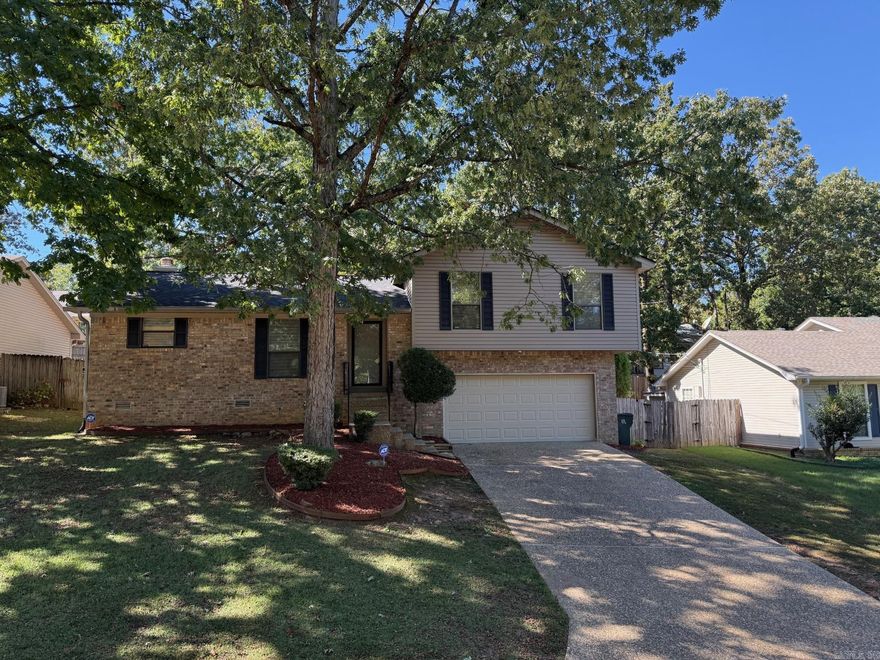 Beautifully maintained home with fresh updates creates move in ready opportunity.   New roof in 2025, new HVAC in 2020, water heater in 2019, floors and stove in 2025 make for a sound investment for new owner.  Wonderful luxury vinyl plank flooring throughout home, no carpets!  Walk in closet in primary suite with ensuite bath as well.  Lots of storage throughout.  Eat in Kitchen and separate dining room and adjacent great room allow for easy entertaining.  Huge back deck area adds even more to the fun spaces.  Built ins around wood burning fireplace with gas logs.  Storm doors front and back allow inviting approach for guests and bringing in even more natural light.  Enjoy the bowed window in the kitchen while preparing delicious menus on clean counters and cabinets with new stainless-steel appliances.  Oversize two car garage with lots of extra storage and easy access to even more storage under house.  Leaf guard style gutters, security camera's/system will convey to buyer for ease of maintenance and peace of mind.  Super convenient location to great West Little Rock shopping, dining, medical, and entertainment options for those with active lives on the go!!