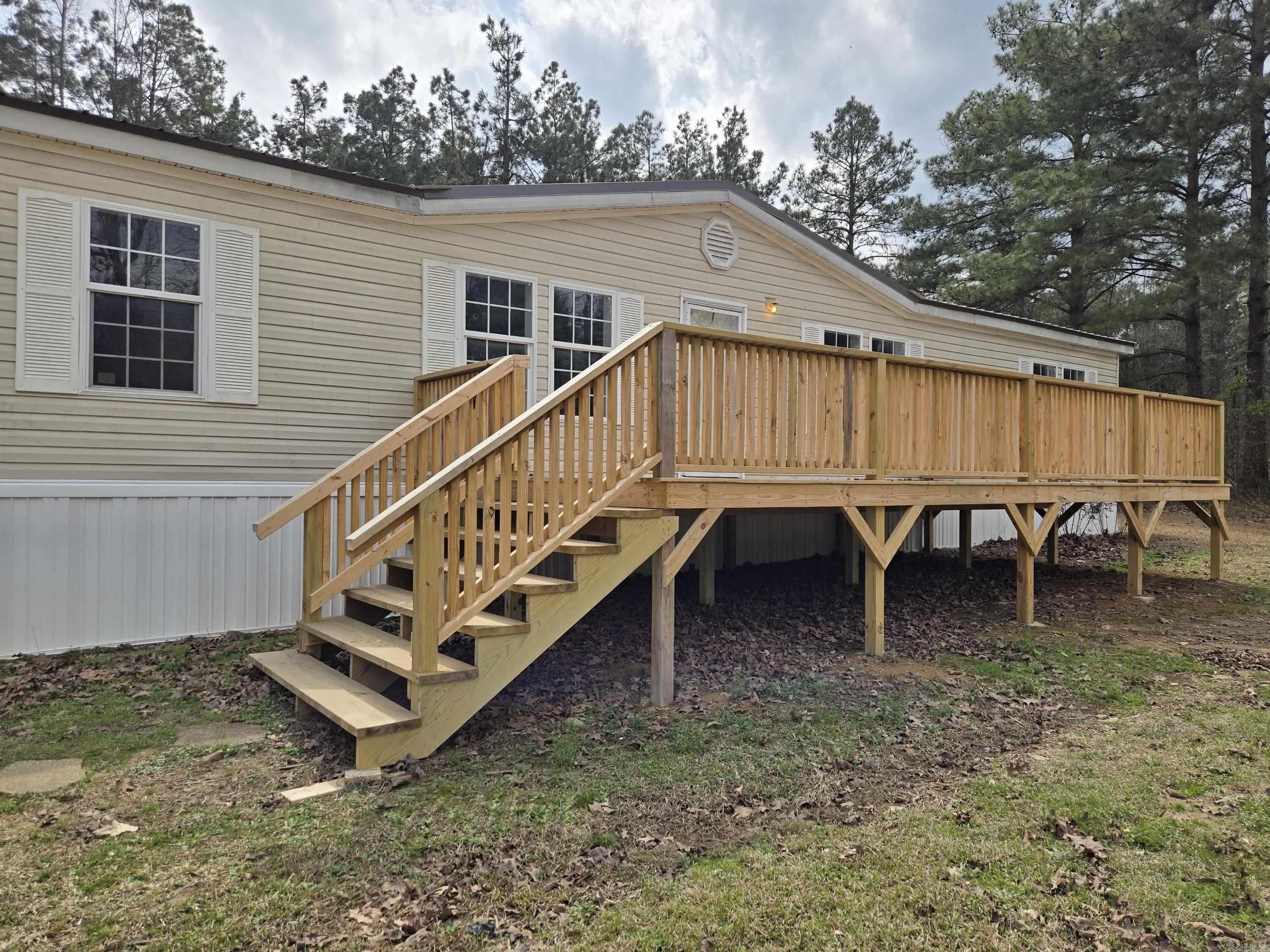 Oh my my, oh heck yeah! Welcome to this stunning 3-bedroom home, perfectly nestled on 3 level acres in a serene country setting while still being conveniently close to the town of Star City. This fully remodeled home offers the perfect blend of country charm and modern conveniences! Key Features: New Metal Roof & Decks: Enjoy peace of mind with a durable new metal roof and two charming wooden decksāone of which is covered, providing a perfect spot for nature gazing and enjoying the beautiful outdoors. Gourmet Kitchen: The heart of the home features a beautifully remodeled kitchen complete with a farmhouse sink, a stylish gooseneck faucet, a butcher block countertop, and a unique soda pop cooler. All new appliances make cooking a delight. Modern Amenities: Almost everything in this home is brand new, from stylish fixtures to modern toilets. Cozy Den: The separate den, highlighted by a wood-burning fireplace, offers a warm and inviting atmosphere during the winter months. Relax and enjoy the ambience while gazing out through the sliding patio doors. Additionally, it is also available with more land, a total of 12.33 acresāsee the second MLS listing for more details or just call in!