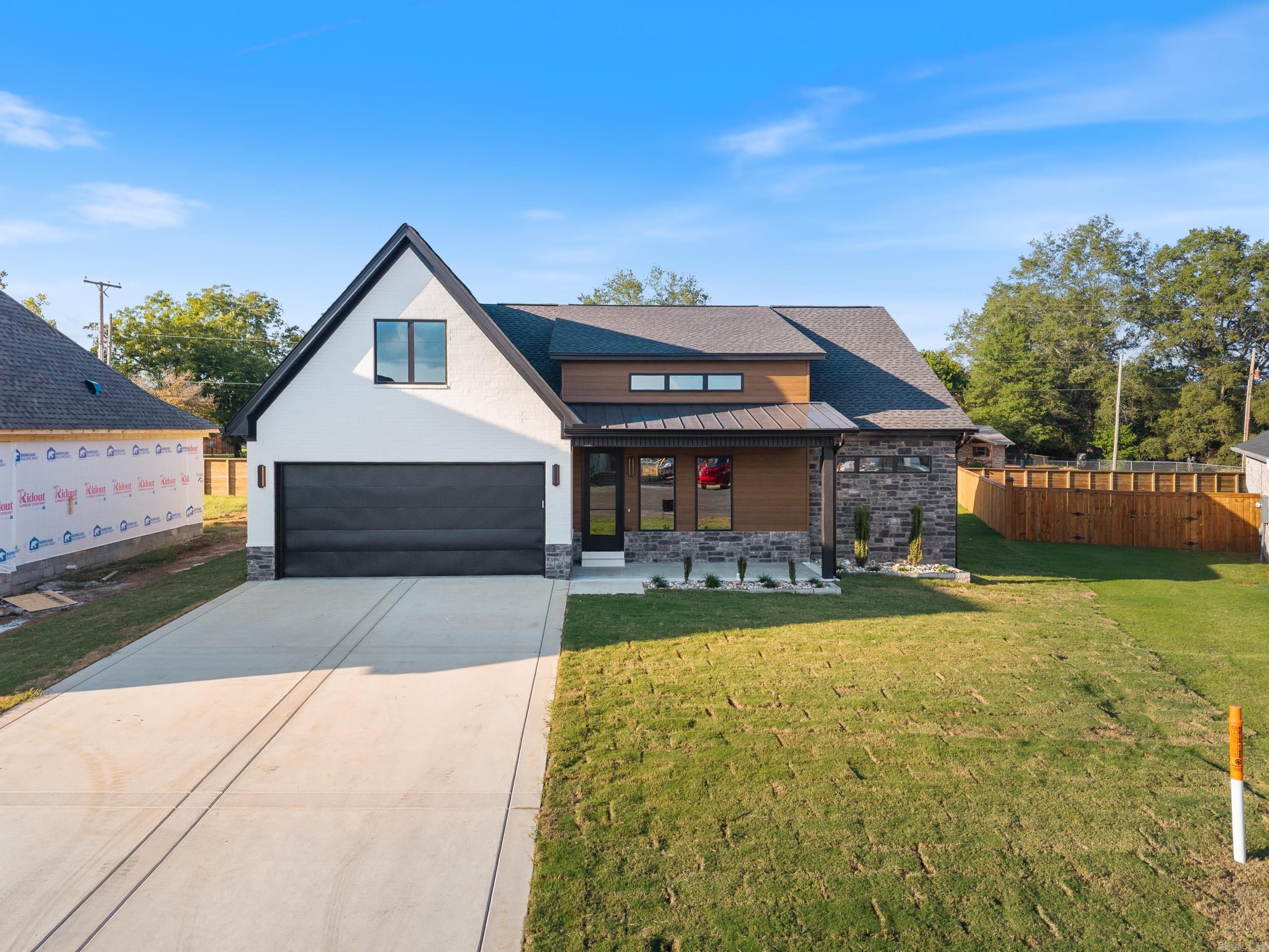 This beautiful new construction home by HDZ STRUCTURES & REMODELING LLC features 3 bedrooms, 2 bathrooms, and a thoughtfully designed layout with high-end finishes throughout. The kitchen is equipped with stainless steel appliances, a gas range, quartz countertops, a convenient pot filler, and a hidden walk-in pantry that adds both style and function. Elegant LVP flooring flows throughout the home, complementing the exquisite tiled showers and carefully crafted details. The vaulted living room ceiling with wood beams, cozy gas fireplace, and plenty of natural light create a warm and inviting atmosphere, while 9-foot ceilings enhance the open feel. Enjoy outdoor living with a covered back patio, perfect for relaxing or entertaining. A laundry room sink adds extra convenience, making this home as practical as it is beautiful. This one is a must-see! Agent see remarks.