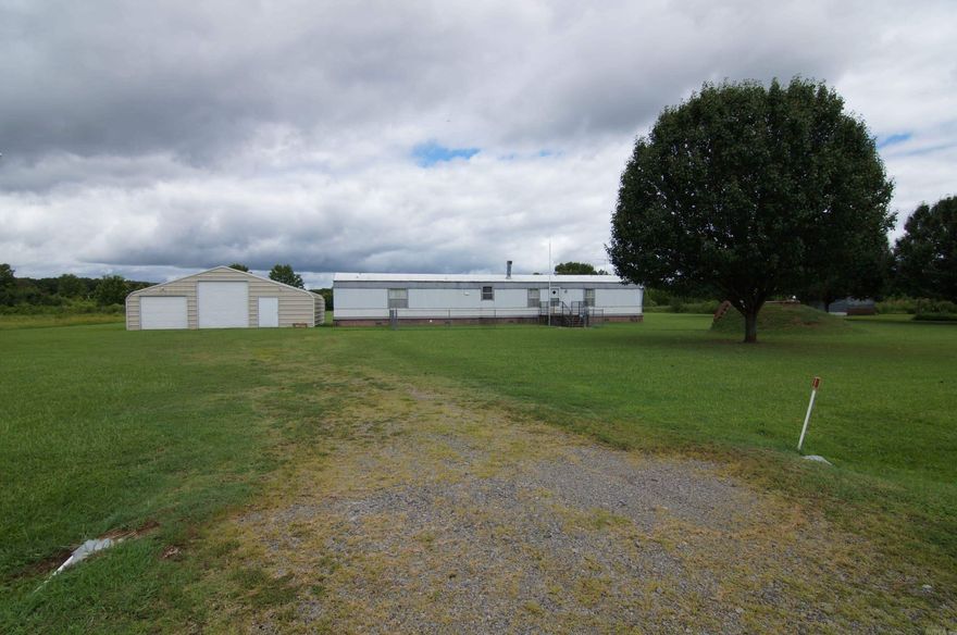 Bring your horses!  Clean, well maintained property on 3.11 acres.  Property includes a 38 x 25 shop/garage with concrete flooring and electricity.  The barn is 30 x 15 also with concrete flooring. Home is on a permanent foundation with brick underpinning.  A generator, video surveillance system and storm shelter add to the list of amenities.  The acreage is fenced and cross fence and ready for your horses.  See this one today!