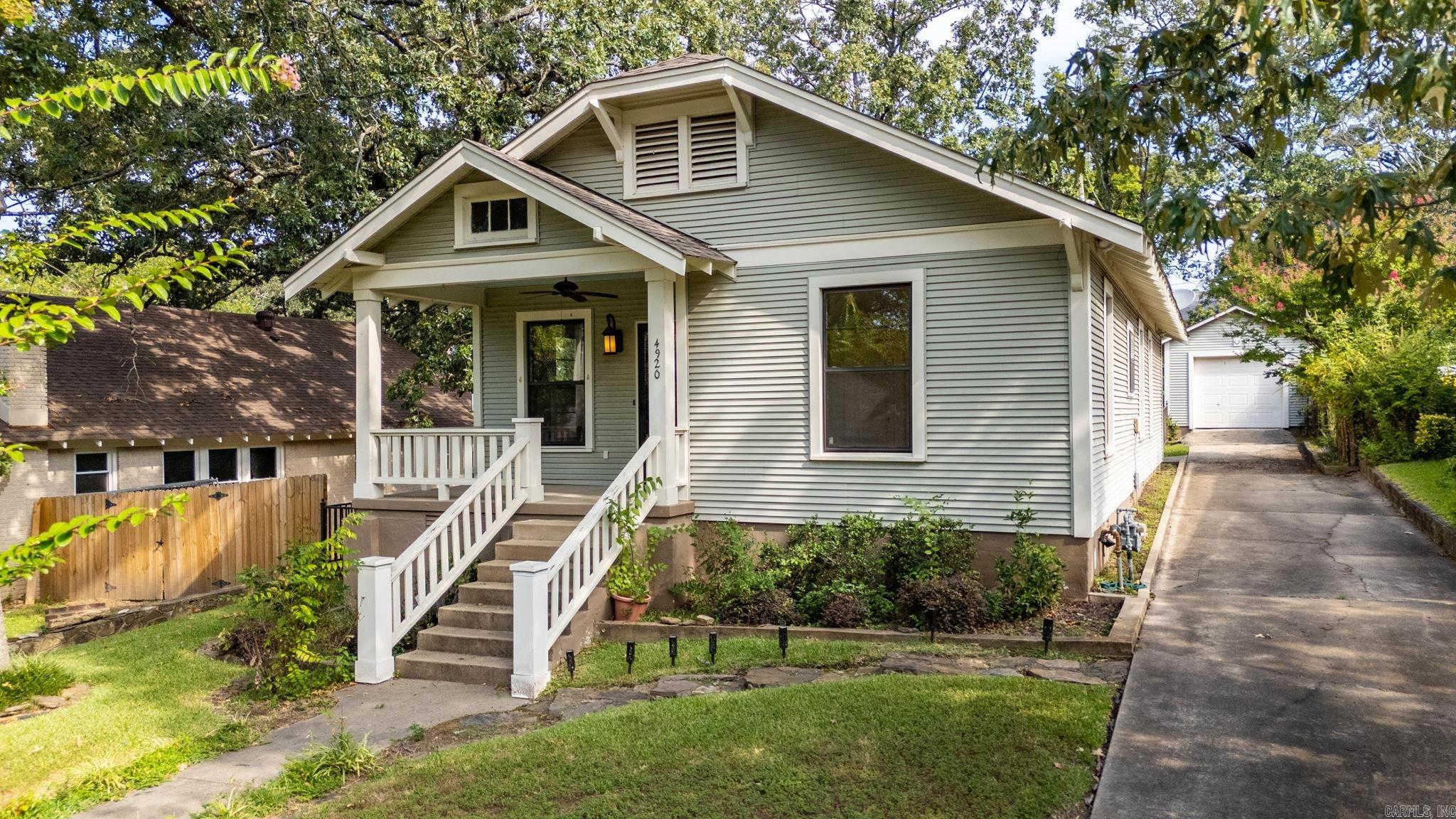 Charming Hillcrest bungalow on a pretty lot backing up to an alley with extra parking. The home also has a one car garage with extra storage behind. The large primary bedroom has en suite bath and a walk-in closet. The second bedroom is en suite bath as well. The living and dining space is all open! The kitchen has a darling black-and-white checked floor, a gas range, a refrigerator that conveys and a breakfast table space. Laundry hook ups are in the home. There is a great deck with two built in umbrellas that overlooks the backyard. Roof replaced in March 2019. Cutest home!