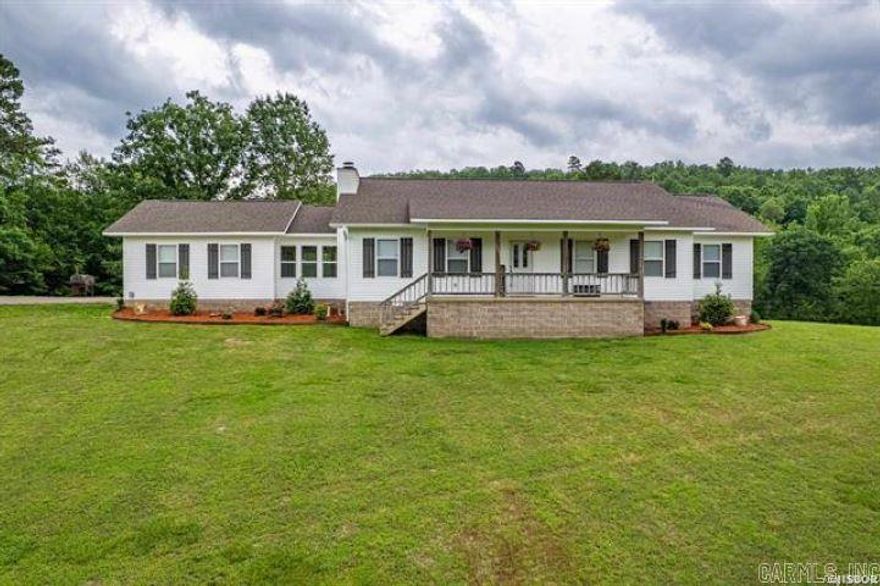 Country Living at Its Finest!  Enjoy wide open spaces and serene vistas in this beautifully maintained home nestled on over 13 acres in the desirable Magnet Cove School District. With more than 2,000 square feet of living space, this charming 3-bedroom, 2-bath home offers a perfect blend of comfort and functionality. Gather around the stunning stone fireplace in the spacious living area or whip up a meal in the updated kitchen featuring a classic farmhouse sink and modern appliances.  Step outside to your own private retreat: an 18' x 33' above-ground pool with a generous deck—perfect for entertaining or relaxing under the stars. A standout feature is the impressive 30' x 40' shop, fully heated and cooled, complete with its own apartment—ideal for guests, a home office, or rental income. The property also includes a handy 12' x 20' utility shed, giving you even more space for storage or projects. This is more than a home—it’s a lifestyle. Whether you're dreaming of a hobby farm, need room to roam, or simply want to soak in the beauty of country life, this property has it all.
