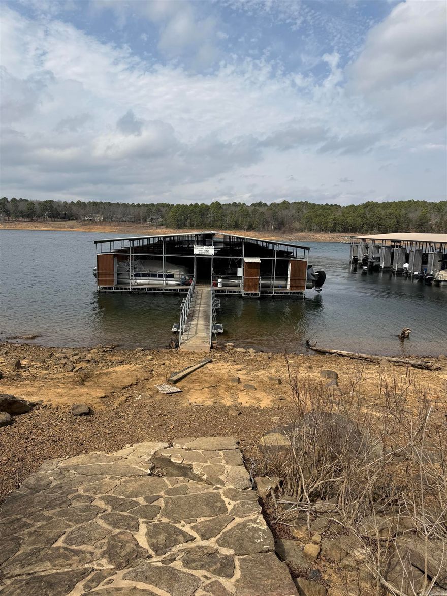 If you're looking for a great location with a lakeview then this one is for you! This 3 bedroom 2 bath home has been redone. Granite countertop and tile     backsplash, new appliances, new flooring and paint. Property also includes a 10x24 boat slip #24 with a storage locker. Boat slip is just a short walk out your driveway down the paved path to your community dock. Come and sit on your back deck and enjoy the lakeview! The POA Dues are $500 per year, Boat Dock is $950.00 per year.