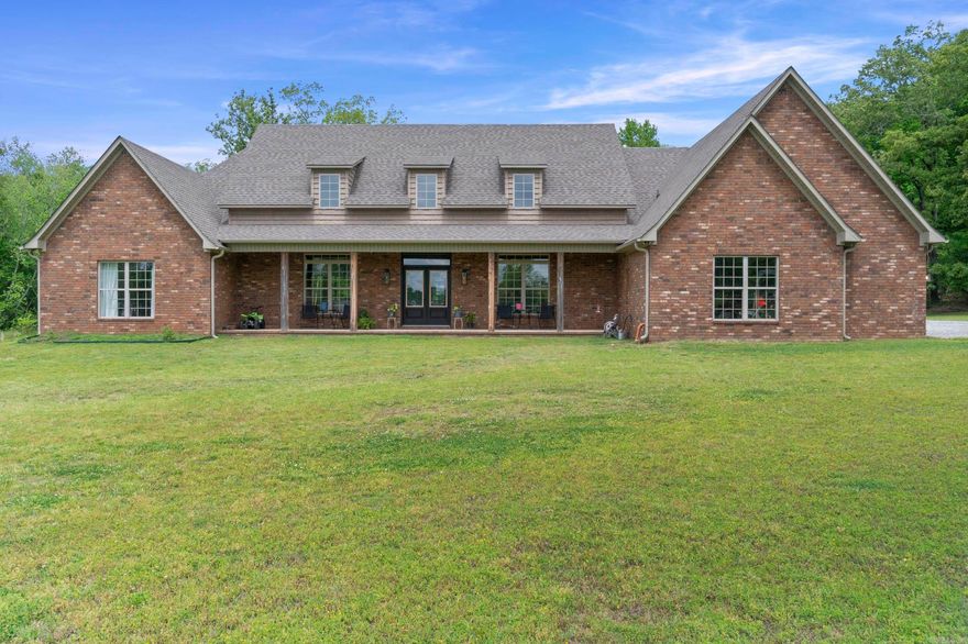 Exclusive access to a stunning 38-acre lake and 80+ acres of scenic land! This one-of-a-kind custom home in Hunters Rest, built in 2021, sits on the canal with gorgeous lake views and direct access—just minutes from city amenities. Offering 4–5 bedrooms and 4.5 baths, the home features a grand open floor plan with soaring ceilings, a spacious family room with brick gas log fireplace, and a formal dining area. The custom eat-in kitchen includes marble countertops, shaker cabinets, a 36" gas range, double ovens, and a walk-in pantry. The primary suite boasts private screened porch access and a spa-like bath with freestanding tub, tiled shower, double vanities, and a large closet connected to the laundry room. Three guest rooms are on the main level, one with ensuite bath. Upstairs offers a bonus room with full bath and ample storage. Complete with a 3-car garage, powder room, and front porch with lake views—this is a rare find!