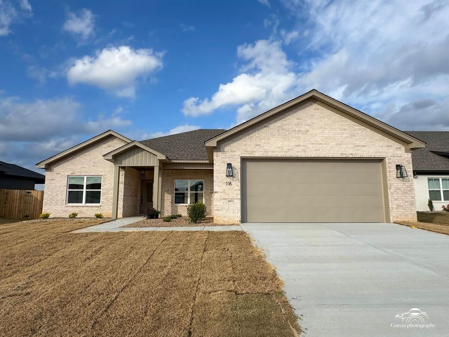 This spacious home features an open concept layout, offering four bedrooms and three bathrooms. The expansive great room is filled with natural light, thanks to large windows, and is complemented by laminate flooring throughout the entire house, while the bathrooms are tiled for added durability. The master suite includes a luxurious walk-in shower and a generous walk-in closet. The kitchen and bathrooms showcase stunning Taj Mahal quartz countertops, enhanced by an elegant backsplash. Additional highlights include a walk-in pantry, a gas range, and a two-car garage. The covered back porch overlooks a fenced-in backyard, perfect for outdoor relaxation and entertaining.