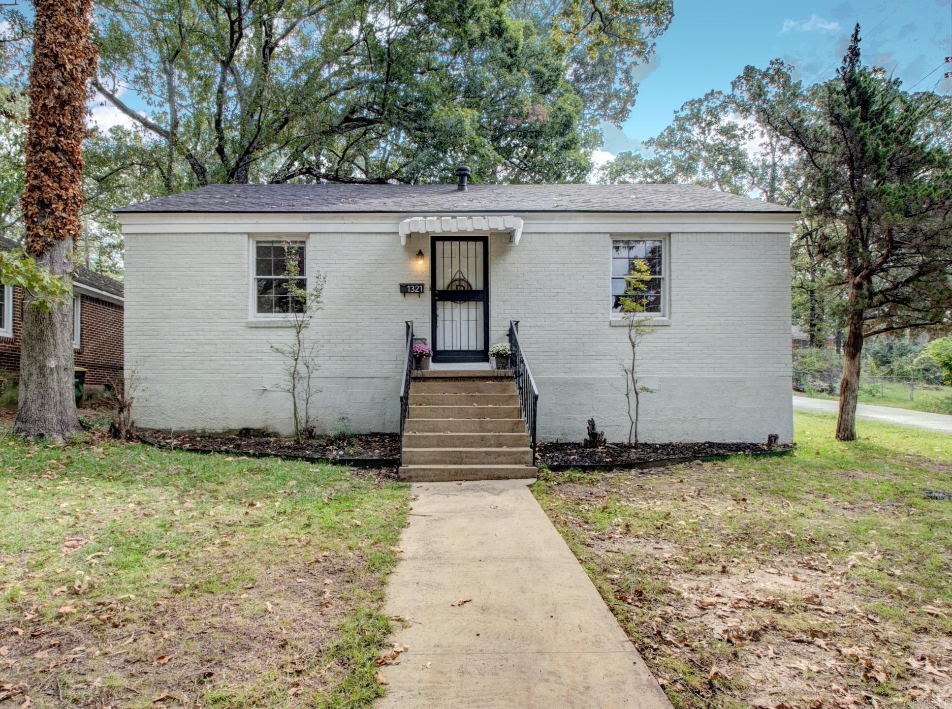 ADORABLE painted brick home on a corner-lot in mid-town is minutes from UALR, downtown, interstate, hospitals, parks & shopping. Meticulously updated to preserve its original character & charm, this inviting & sunny open-concept in the living, dining, & kitchen areas with a center island/cooking station is perfect for entertaining. Newer stainless steel kitchen appliances (refrigerator conveys), gleaming hardwood floors, a NEW ROOF & hot water heater makes this home a smart buy. Nice size laundry/pantry & storage, along with oversized bedrooms, ample size closets & a full bath provides comfort & functionality. There is extra space that allows for a new bath addition, allowing an opportunity for growth & value. Enjoy the side-load entrance with a covered porch or carport, a detached garage w/ extra storage & plenty of parking. The fenced backyard is perfect for a garden, deck, recreational space OR with city approval, the garage or huge backyard could potentially be expanded into an accessory dwelling unit, providing extra income for the homeowner & housing for college/med students. A blend of charm, convenience, updates & value makes this home special. Welcome to Mid-Town!