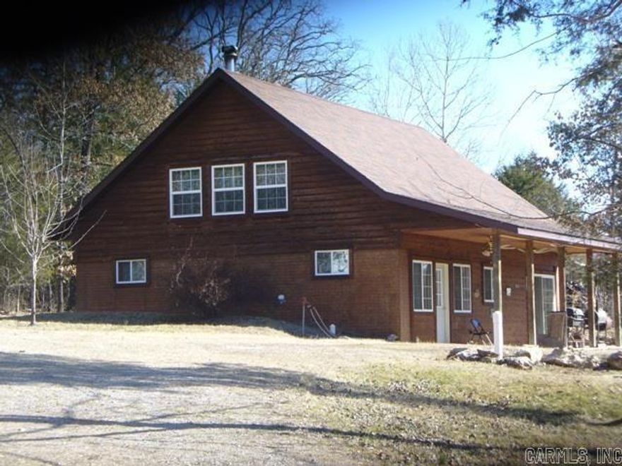 Charming country-style cedar home on 1.2 acres just minutes from the scenic White River. This 2-bedroom, 2-bath home offers 1,760 sq ft of living space with a spacious eat-in country kitchen perfect for family meals or entertaining. Enjoy year-round comfort with a cozy wood stove and 320 feet of covered porch, ideal for relaxing and enjoying the peaceful setting. Property includes two large carports—one partially enclosed and currently used as a workshop. The land features several mature walnut trees, multiple fruit trees, and a fully enclosed, established garden ready for your green thumb. A perfect blend of rustic charm and functionality. Priced at just $199,000.