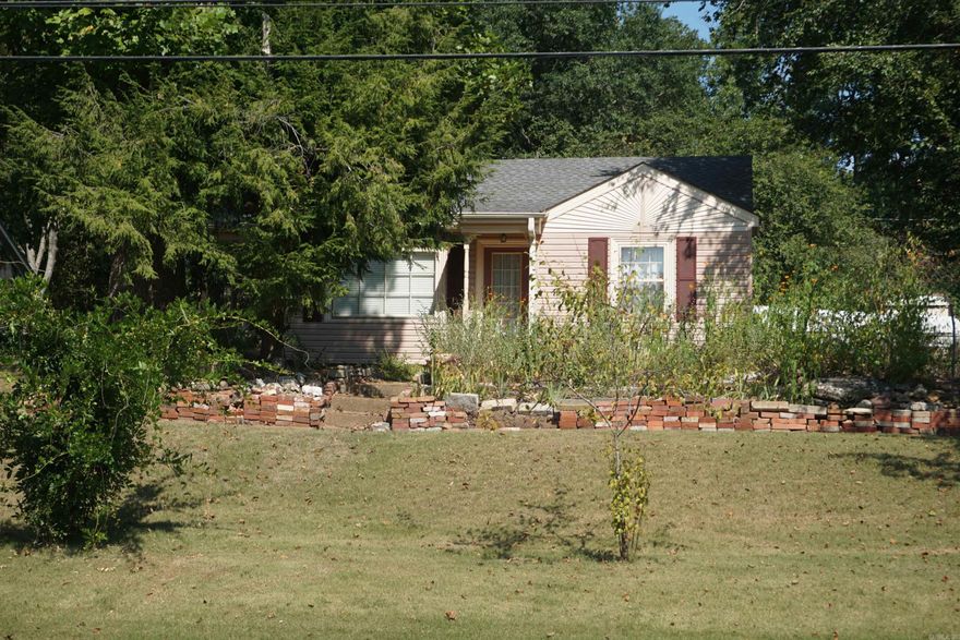 Super sweet little house with so much charm. Move in ready and comes partially furnished with living room furniture and lots of household items left in the kitchen and laundry room. The house has central H&A and the is a breaker panel for the house.  There is a small 2 room house in the back yard with an adorable front porch and has it's own breaker box and a cast iron wood heater. This was  a "she shed before that term was invented" There is also a small metal storage building and a metal carport and the yard  has chain link fencing. Lots of flower beds full of heirloom flowers.  Such a cute little place in a great location and within walking distance to the School, Library, Post Office or the Bank