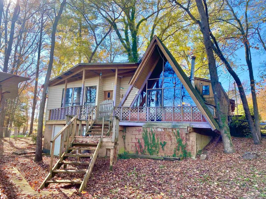 Are you ready for your own little slice of fisherman's heaven?! 2 Lake front lots! Welcome to Harris Brake Lake, located Just minutes from all the West Little Rock amenities in the quiet little town of Perryville. This is a unique A-Frame lake front home sitting on TWO LOTS!  Two mini-splits installed just 3 years ago!  Tons of natural lighting! Windows over look out over the lake and a covered sitting area. Wood burning stove in kitchen will heat up the entire place in no time!   You have your own private dock, and 2 Public launching ramps nearby!  Storage building on 2nd lot could be easily removed and you can build something new!