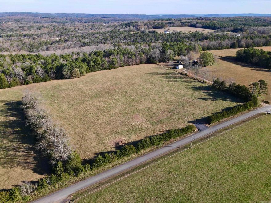 This picturesque farm, located on a paved county road, offers the perfect blend of functionality and natural beauty. A newly constructed entrance welcomes you into a pristine open pasture, ideal for grazing livestock or selecting one of several potential building sites that showcase stunning views of the Boston Mountains.    Beyond the pasture lies a mature pine and hardwood forest, accessible through a recently improved and widened trail system, perfect for ATV exploration. The property features a seasonal creek that meanders across the land, enhancing its appeal as a serene retreat.    Wildlife enthusiasts will appreciate the abundant habitat that attracts deer, bear, and turkey, making it a haven for hunters and nature lovers alike. Located just a short drive from Greers Ferry Lake and the Little Red River, you’ll enjoy access to excellent boating, fishing, and world-class trout fishing opportunities.    Utilities, including electricity, rural water, and internet, are available, making it easy to build your dream home or getaway. Please note: Mineral rights do not convey.