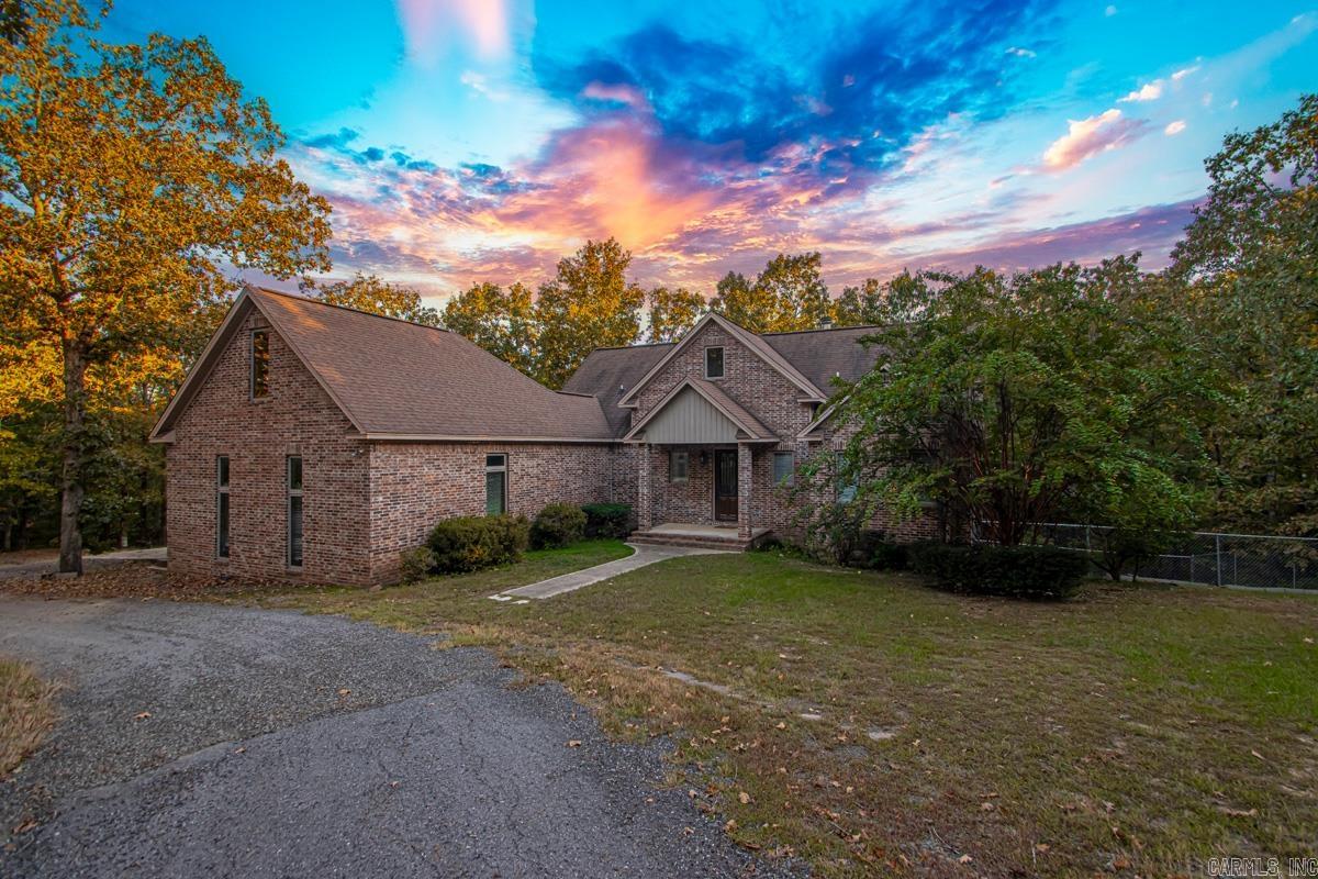 Whoās looking for the perfect family retreat with room to grow and breathe? This stunning custom-built home sits on 5 beautiful acres in Cabot and offers space, comfort, and charm at every turn. Featuring 5 bedrooms, 3.5 baths, two living rooms, and two laundry rooms, this home is ideal for a large or multi-generational family. Several bedrooms include private ensuites, giving everyone their own space. Step inside to a spacious living room with vaulted wood ceilings, a gorgeous wood accent wall, and abundant natural light from large windows overlooking the countryside. The open kitchen and dining area offer plenty of cabinetry and space for family gatherings. The primary suite includes a private deck, perfect for morning coffee or quiet evenings, plus a luxurious ensuite bath with dual sinks, a jacuzzi tub, and a large walk-in shower. Upstairs, youāll find an open loft area and two additional bedrooms. The lower level offers another large living area, two more bedrooms, two full baths, and a second laundry room ideal for guests or extended family. Enjoy outdoor living with a fenced backyard, perfect for kids, pets, or simply soaking up the peaceful country surroundings.