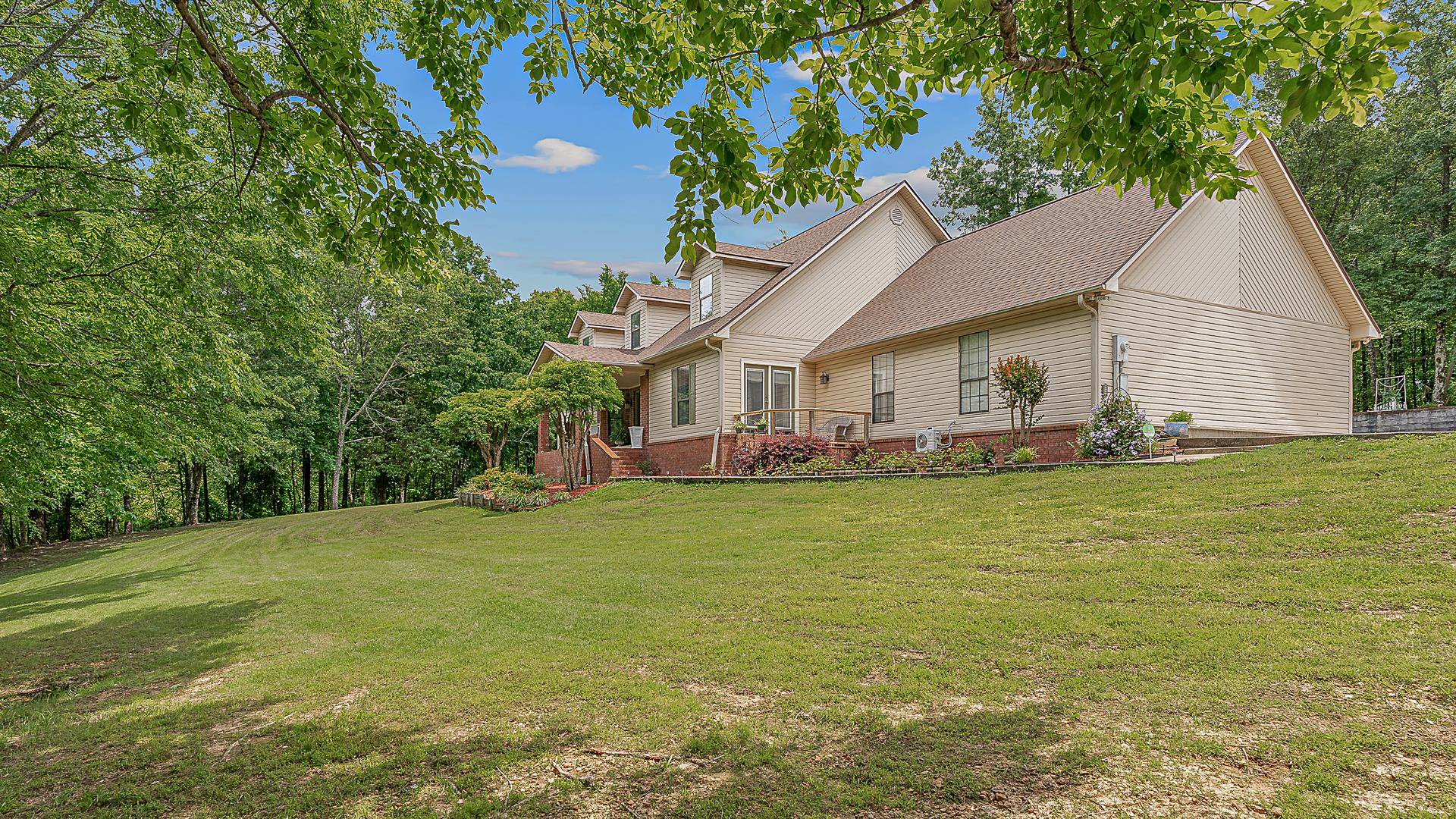 Welcome to this custom, one-owner home on ~4.5 acres atop scenic Crowley’s Ridge. Designed with quality in mind, it features 2x6 construction, 5/8” plywood on walls/roof decking, and a stocked ~1.5-acre pond. The spacious layout includes 4 bedrooms, 3 full baths, a large living room with gas fireplace, formal dining, office, and a new heated/cooled sunroom added in 2024. The main-level primary suite boasts a jetted tub, two-seat shower, and private deck with pond views. Two bedrooms are downstairs, with two more and a library upstairs. The kitchen is fully equipped with under-cabinet lighting, Electrolux fridge/freezer (2019), and convection cooktop/oven (2018). Extras include a large laundry with walk-in pantry, five raised garden beds, an 8x16 barn-style greenhouse, chicken run, 30x40x14 shop, 300-amp electric, natural gas, and an 80-gallon smart water heater (2020). Just 13 mi. to Jonesboro, 6 to Harrisburg, and 48 to Memphis—this is a rare blend of comfort, quality, and convenience.