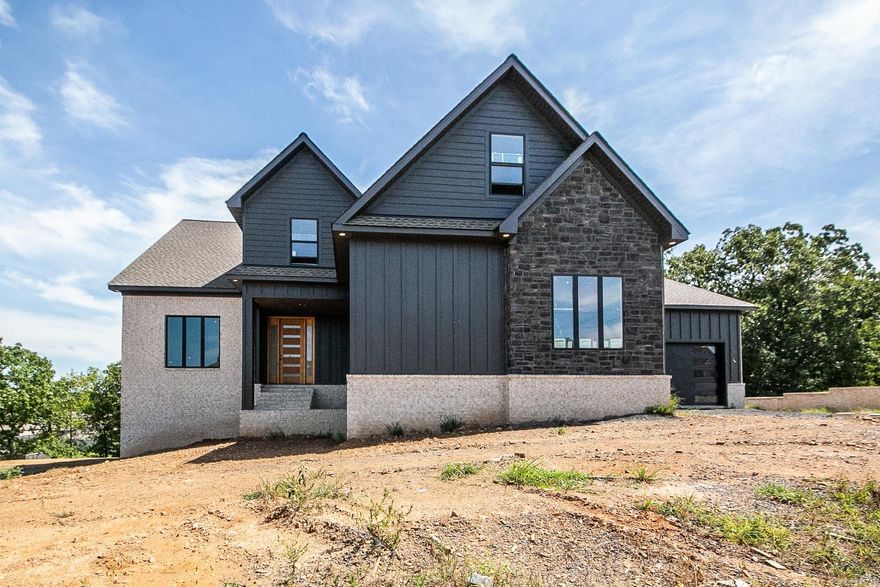 Executive home is in a prestigous neighborhood. Custom home on two lots. This HUGE 6 bedroom 4 bath and two 1/2 bath is perfect for your family! The living room has a vaulted ceiling that continues to the outside to a 448 sq. foot covered patio with a fireplace. Bottom floor (in-law Suite) has it's own garage, kitchenette, family room/Game room and more. Second floor has a master suite to die for! Giant closet! Great master bath! Huge kitchen with all the upgrades! Upstairs has three big bedrooms. This home has a media room, game room, several decks, porches and so much more. Two laundry rooms. This homes has everything you are looking for and more. Call today!