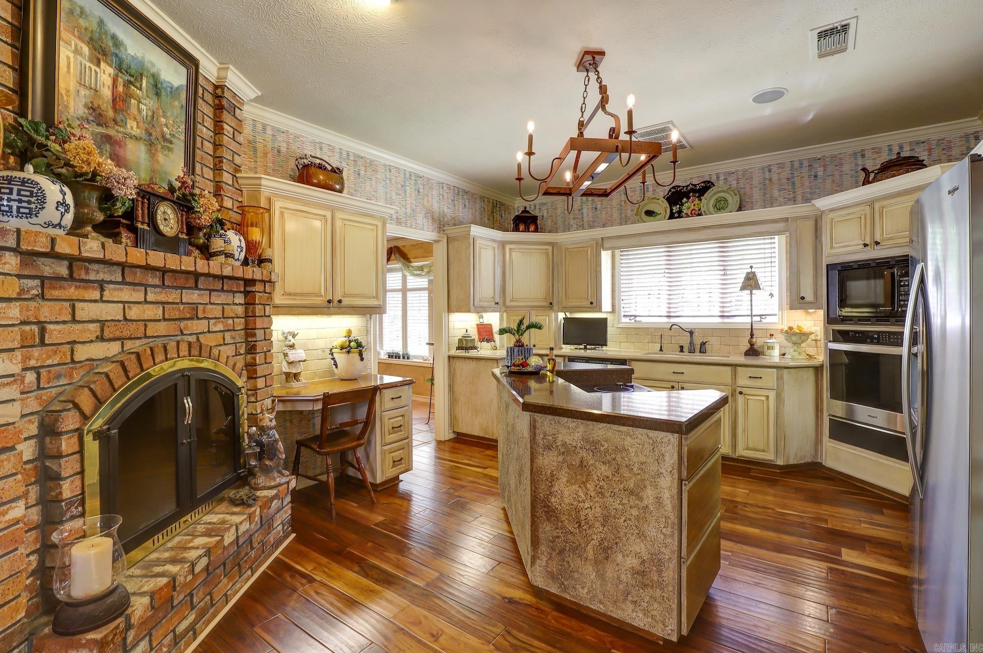 Discover this unique 2-story custom home filled with character and quality finishes! Tucked away on a beautifully landscaped corner lot, this property offers a private backyard retreat complete with a fire pit, pergola, and built-in grill areaāperfect for entertaining. Inside, you'll love the spacious kitchen featuring quartz countertops, a tumbled marble backsplash, a downdraft cooktop, and a central island. The open family room shares a cozy double-sided gas log fireplace with eat-in kitchen, creating a warm and inviting atmosphere. Plantation shutters add a touch of elegance throughout. Donāt miss the āsecretā game roomācomplete with a pool table, all-in-one exercise/weight unit, and foosball table, all conveying with the home! Other highlights include a huge utility room with built-ins, workspace, and sink, an in-home vacuum system, and a stamped concrete driveway. A truly special home that blends comfort, functionality, and fun!