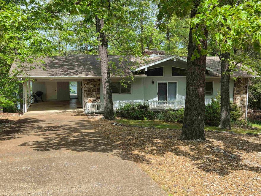 Privacy and Lakefront living, what more could you ask for? Deck expands the length of the back of the home and can be accessed from 2 bedrooms, living room and carport. The lower level has been updated with tile flooring, bathroom has a large walk-in shower. 2 kitchens, one on each level, both having dw, stove, fridge. Seller added two sun rooms to the lower level for more options of viewing the lake. Main level has three bedrooms, 2 baths, open living-dining area with 2 sided fireplace in the middle. Large Picture windows and vaulted ceilings let in tons of natural light. Carport with storage plus large storage room underneath for all your lake toys and yard tools. There is a vacant lot on both sides of the home for privacy & the land sits on the edge of a cove. All electric home w/wood burning fireplace and wood burning stove for back up. NAEC electric service also has an option for NEXT fiber optic internet service. Can be purchased furnished.