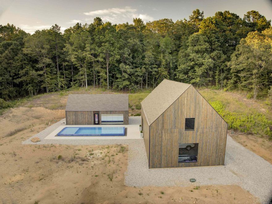 One of a kind opportunity to own a architectural gem in Saline County. Architecture by DEN Architects this property boasts a 2 bedroom  and 1.5 bath pool house, 4 car shop that is completely heated and cooled with its own full bathroom, 5 acres, custom top of the concrete pool, main house pad already built and ready, and all utilities for the main home including septic tank and underground propane installed for future use. Exterior of home features spruce wood that has been stained and sealed. Foam insulation throughout ensures it will be energy efficient year around. The interior floors are also spruce wood that has been intentionally left unfinished to allow for natural wear and age to be sealed when the desired finish has been reached. Floor to ceiling windows throughout brings the outside in for you enjoy. Custom rift-sawn white oak cabinets are absolutely gorgeous and unlike anything you have seen. Once entering the 4 bay shop you will see ample storage, as well as a basketball court area that is large enough to accommodate a high school 3-point line. Come today to see this beautiful home and build your future!