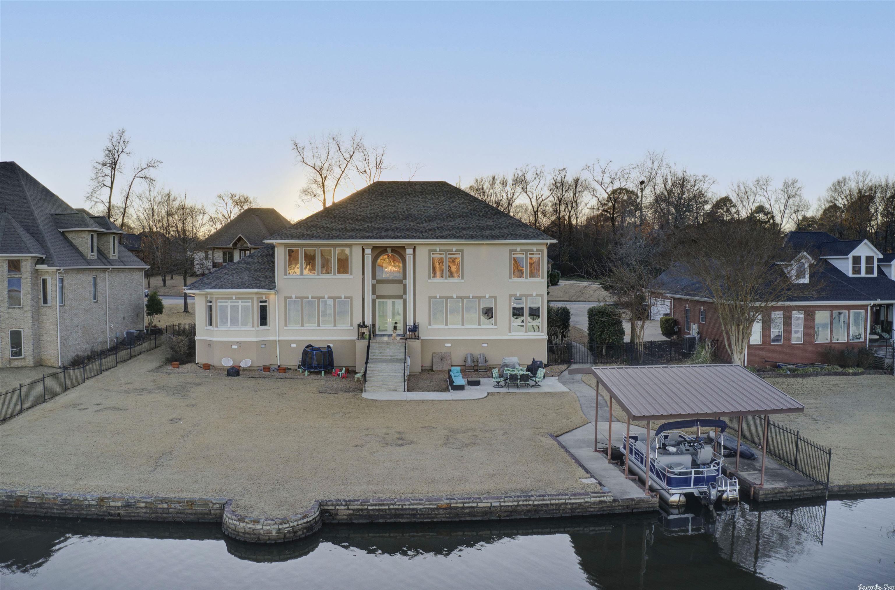 LAKEFRONT HOME!! Walk into this beautiful home and enter into a grand two-story living room with jaw dropping views of Hurricane Lake. The newly remodeled kitchen is a chef's dream. Start off your morning w/ a hot espresso w/ the built-in Miele Espresso machine. This large kitchen comes w/ double cooling drawers for extra cold storage or the perfect spot for kids refrigerated snacks, Sub Zero fridge, built-in icemaker, quartz countertops. Walk-in pantry. Sunroom. Covered boat dock. Large bedrooms. MUST SEE!