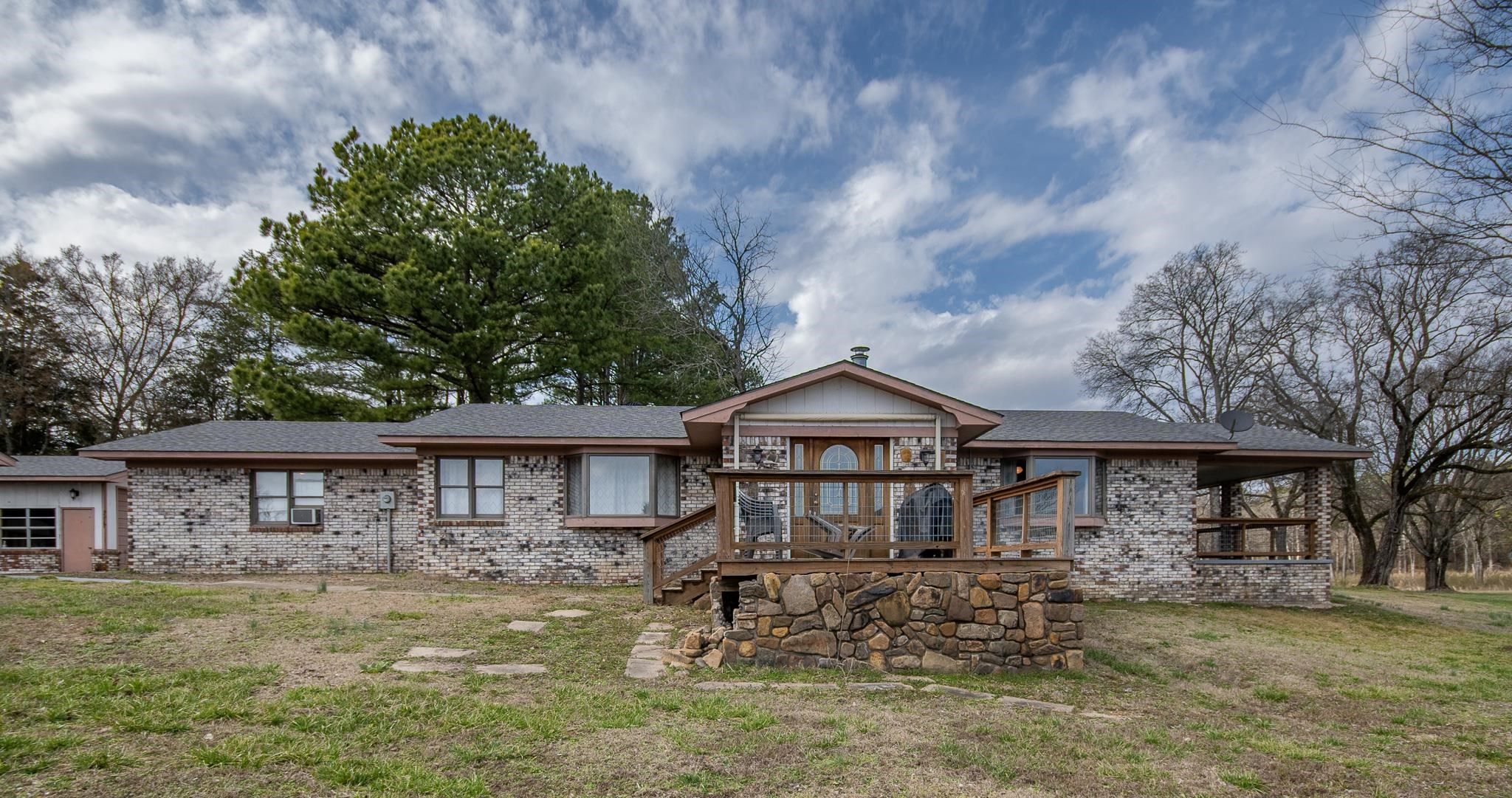 Great brick home on 81.54 acres with 20x50 barn with 20x50 lean to, 1 car garage, 3 gazebos all overlooking this amazing property. Year around creek borders on 2 sides (Two Mile Creek) and Hwy 71 frontage. 3 large bedrooms, laundry room, great dining room for family gatherings, large bay windows. Will subdivide. Located in Mena, AR. Agents, see remarks.
